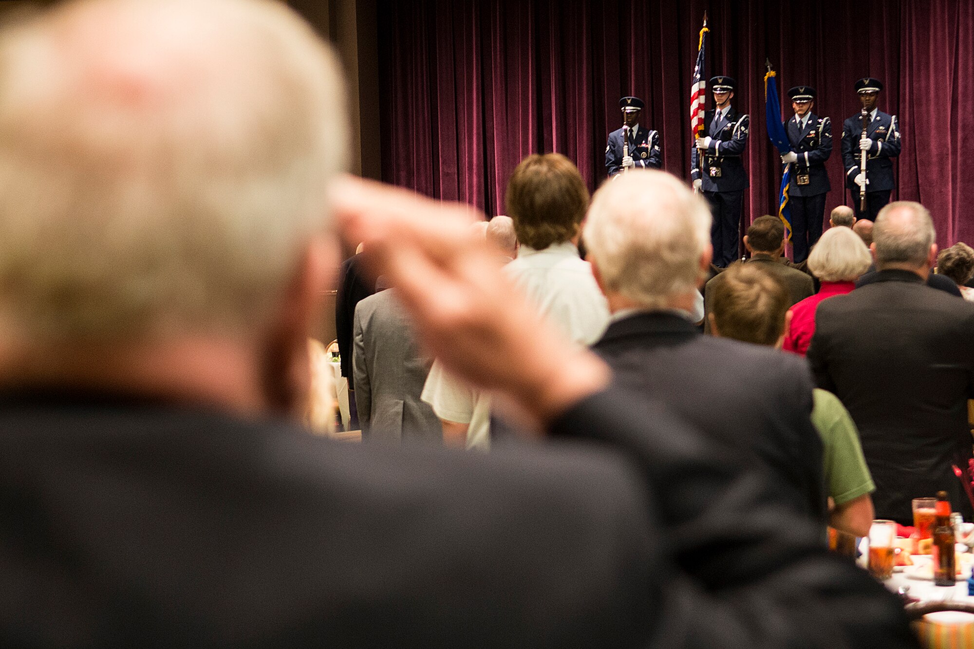 An Air Force veteran salutes the colors during the singing of the National Anthem at the 307th Bomb Wing Combined Bomber/Tanker Reunion, April 26, 2014, Bossier City, La. Approximately 200 former members attended the reunion, ranging from service during World War II to the wing's deactivation at Lincoln Air Force Base, Neb. in 1965. (U.S. Air Force photo by Master Sgt. Greg Steele/Released)