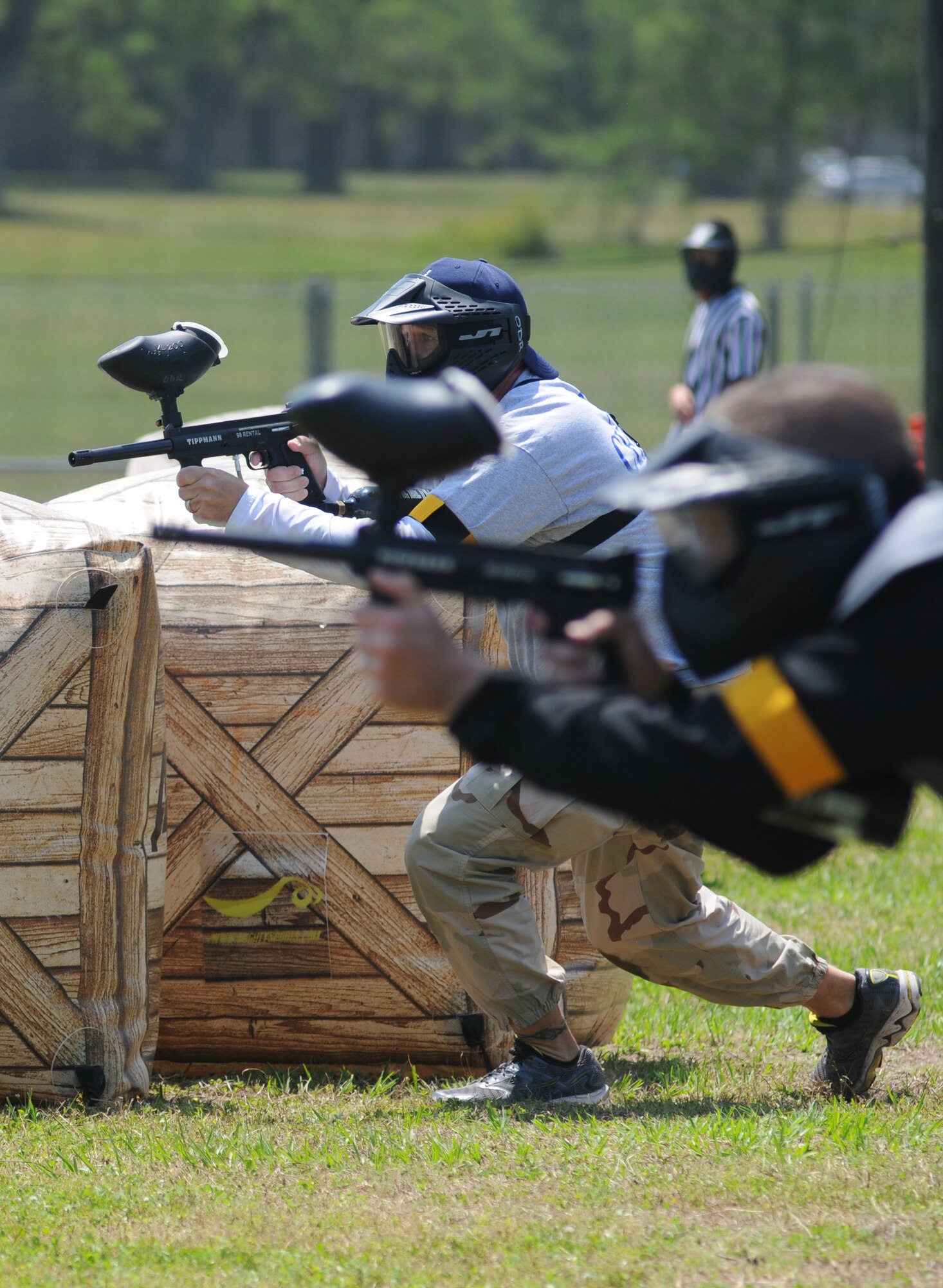 Chief Master Sgts. Mike Lemond, 2nd Air Force, and Chief Master Sgt. Jason Devereaux, 81st Aerospace Medicine Squadron, close in on the enemy during a friendly match between the Chiefs and the Colonels at the paintball facility grand opening April 25, 2014, southeast of the commissary at Keesler Air Force Base, Miss.  The paintball facility was funded with a portion of the 2013 Commander-in-Chief Installation Excellence award funds.  (U.S. Air Force photo by Kemberly Groue)