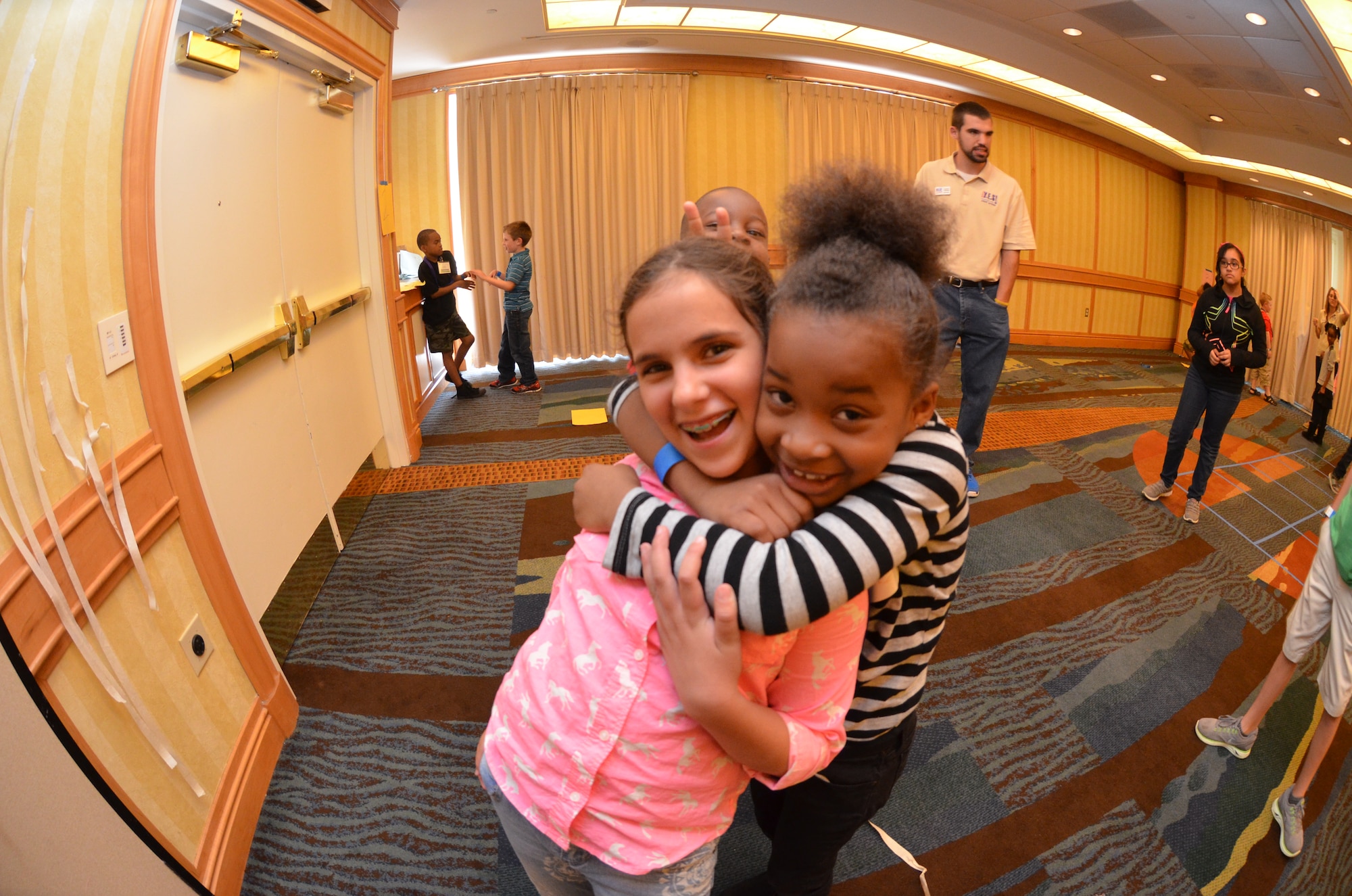 Isabella Sanchez (left), the 10-year-old daughter of Staff Sgt. Howard Sanchez, 482nd Fighter Wing, Homestead Air Reserve Base, Fla., embraces a hug by Ann Merie Darling, another Air Force Reserve family member who participated in a Yellow Ribbon Reintegration Program event April 25-27, 2014, in Maryland. Youths attending Yellow Ribbon events experience targeted age-specific games as well as family-bonding activities. (U.S. Air Force photo/Staff Sgt. Kelly Goonan)