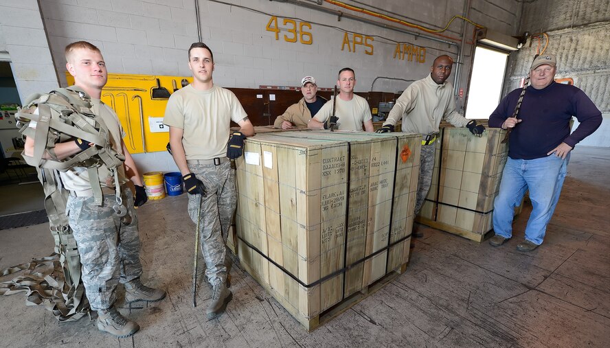 Military and civilian personnel of the 436th Aerial Port Squadron in-transit munitions section are shown with pallets of LUU-2B/B aircraft flares with parachutes as they prepare to weigh and inventory a newly received shipment on April 10, 2014, at Dover Air Force Base, Del. From left to right are: Senior Airman Clayton Dorris, Senior Airman Justin Sims, Garry Ernst, Technical Sgt. Paul Osborn, Senior Airman Jamaal Austin and Leonard Estabrook.  (U.S. Air Force photo/Greg L. Davis)