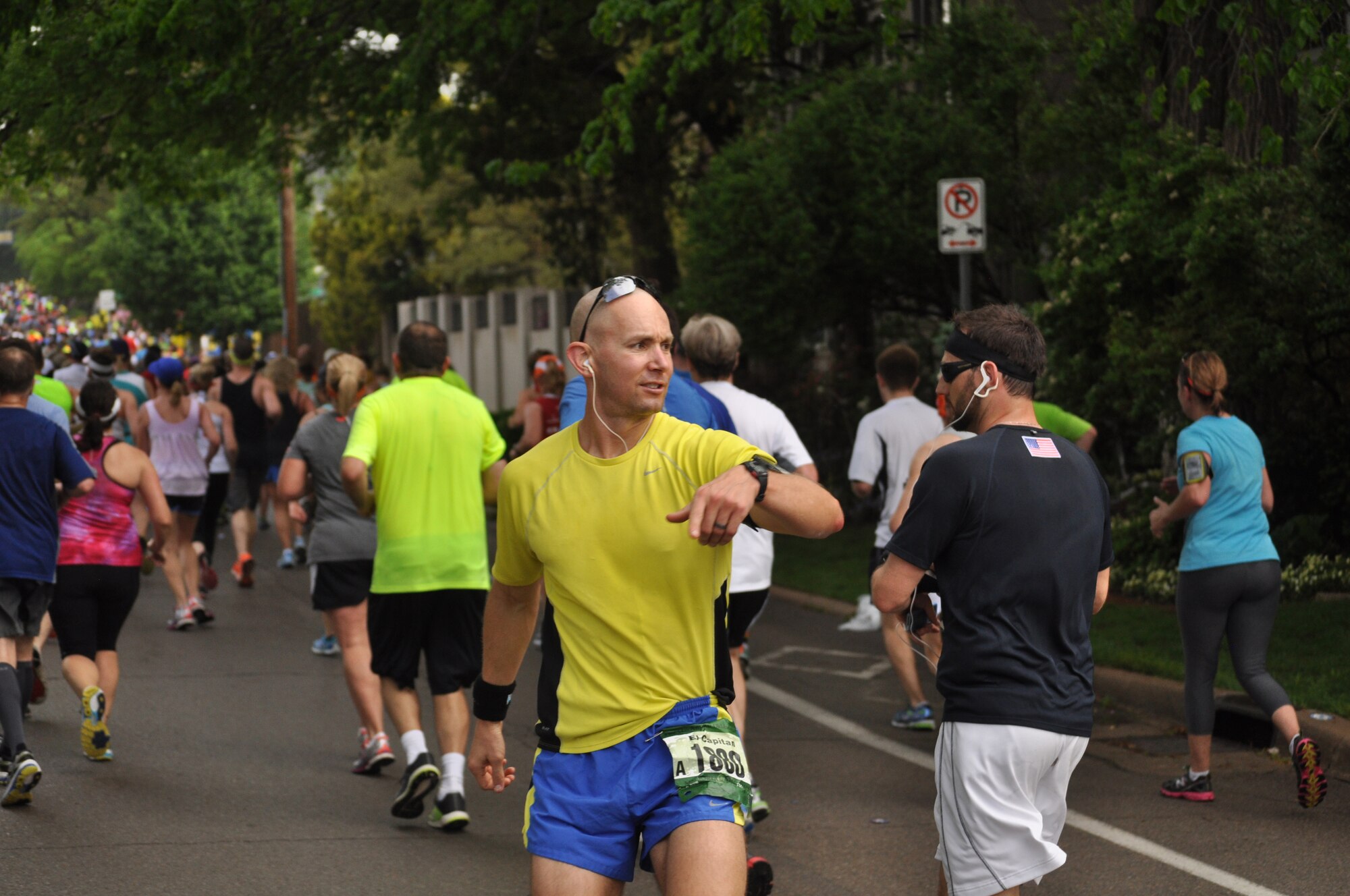 Capt. Zach Anderson, Chief of Public Affairs, 931st Air Refueling Group, turns to encourage other runners before attacking "Gorilla Hill" about 6.2 miles into the 2014 Oklahoma City Memorial Marathon, April 27. Anderson, who runs several marathons a year, recently returned from a deployment to Honduras where he served as the Director of Public Affairs at Joint Task Force Bravo. He completed the 26.2 mile course in 3:57. (Air Force photo by Master Sgt. Brannen Parrish)