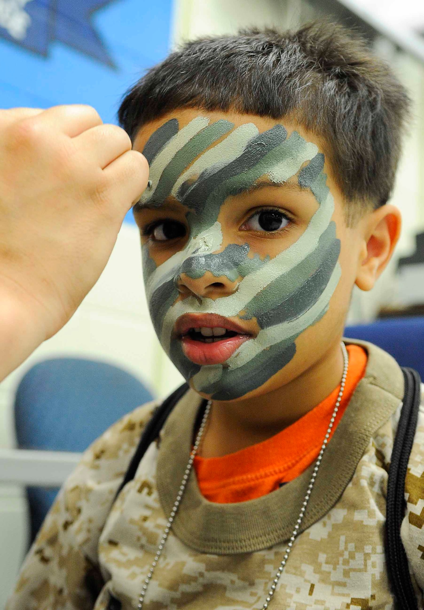 Myles Chivis gets his face painted at Hurlburt Field, Fla., April 26, 2014. Military children participated in Kids Understanding Deployment Operations to see what their parents go through during deployments. (U.S. Air Force photo/Airman 1st Class Andrea Posey)