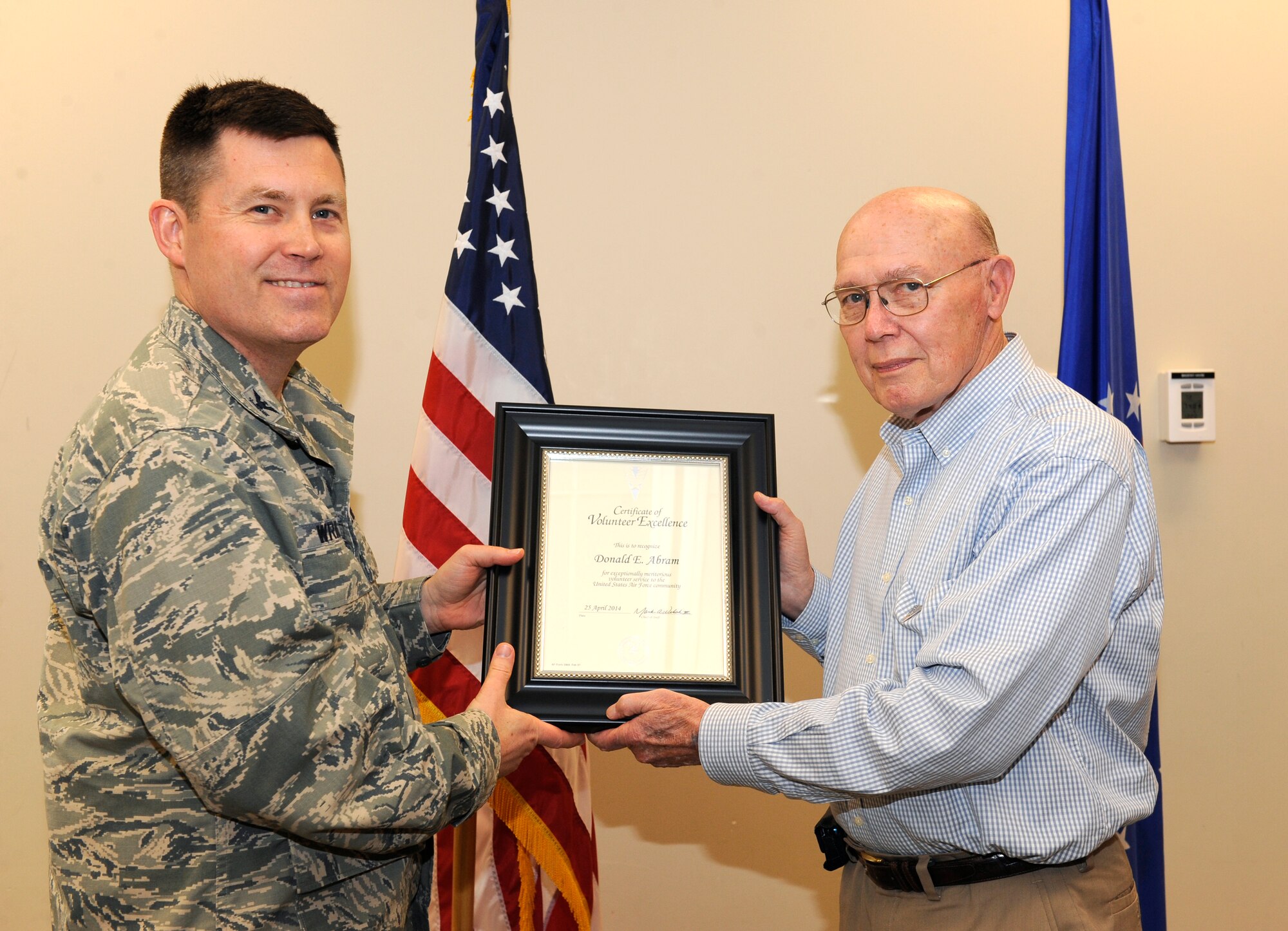 (Ret.) Navy Capt. Donald E. Abram, Buckley Pharmacy volunteer coordinator, is recognized during the Volunteer Excellence Award ceremony April 28, 2014, at the chapel on Buckley Air Force Base, Colo. This award is given to non-active duty military personnel to encourage retirees, military family members and civilian personnel to use their time to help others. (U.S. Air Force photo by Airman 1st Class Samantha Saulsbury/Released)