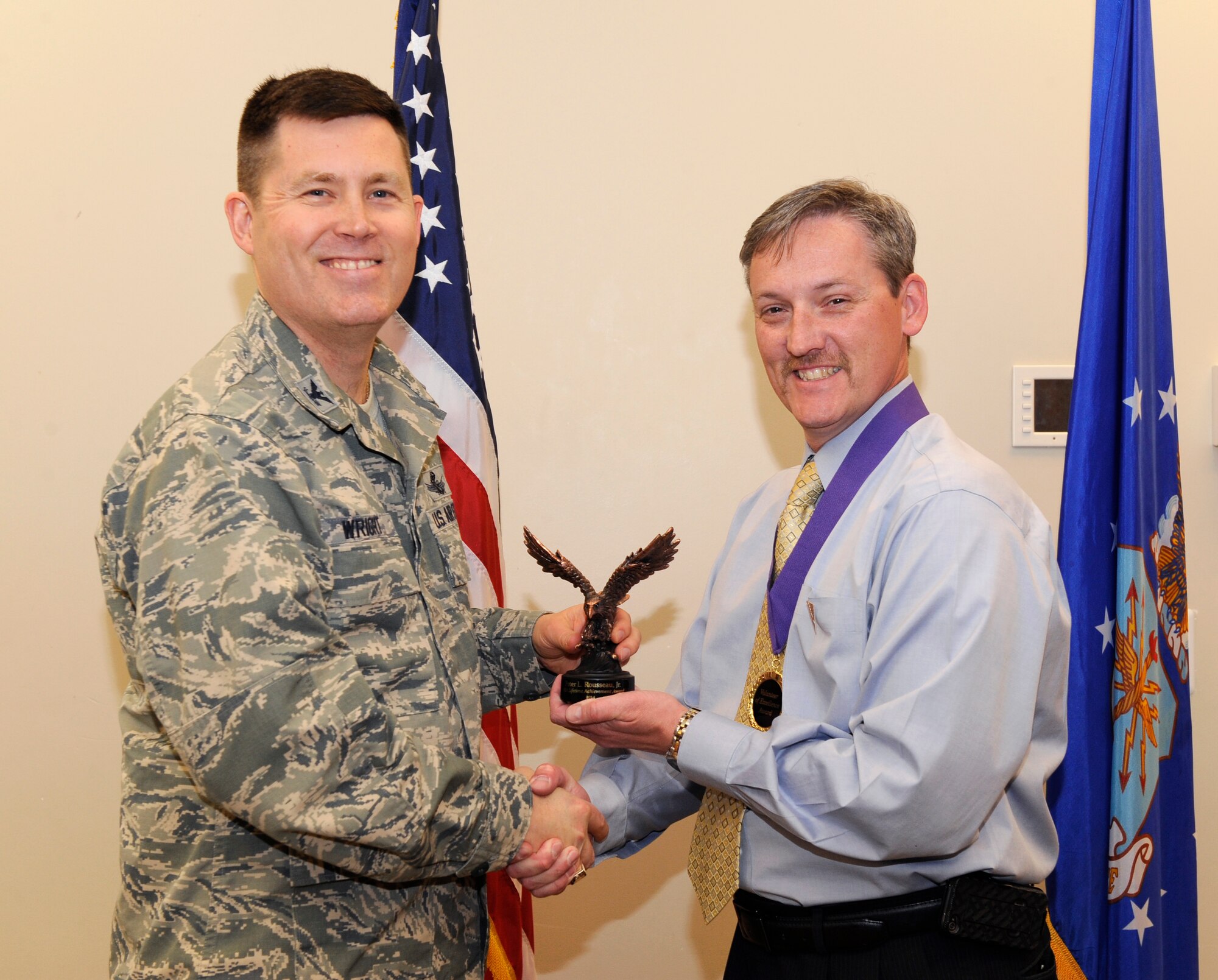 Peter Rousseau Jr., 460th Operations Group test lead Space-Based Infrared System sustainment, is recognized during the Volunteer Excellence Award ceremony April 28, 2014, at the chapel on Buckley Air Force Base, Colo. This award is given to non-active duty military personnel to encourage retirees, military family members and civilian personnel to use their time to help others. (U.S. Air Force photo by Airman 1st Class Samantha Saulsbury/Released)