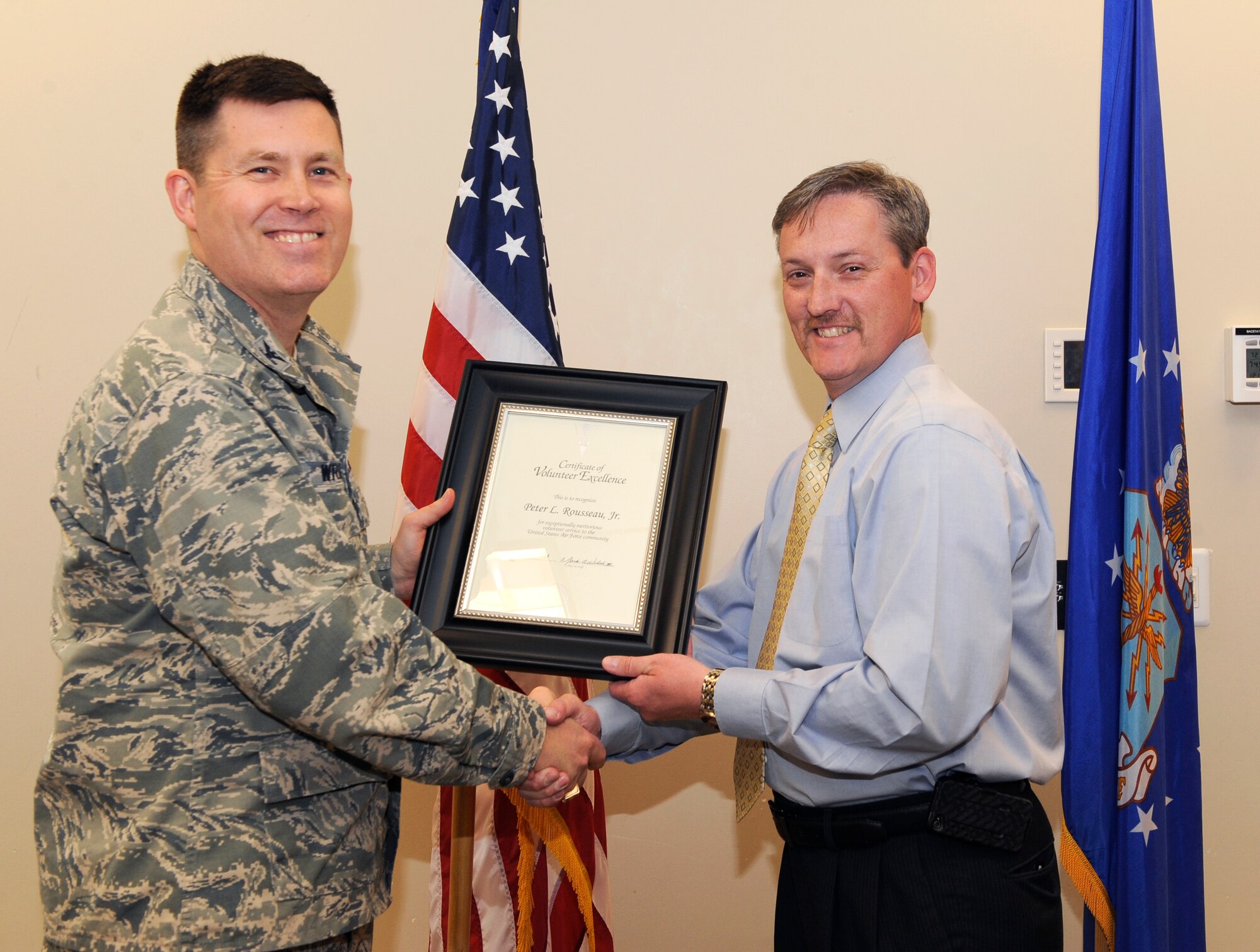 Peter Rousseau Jr., 460th Operations Group test lead Space-Based Infrared System sustainment, is recognized during the Volunteer Excellence Award ceremony April 28, 2014, at the chapel on Buckley Air Force Base, Colo. This award is given to non-active duty military personnel to encourage retirees, military family members and civilian personnel to use their time to help others. (U.S. Air Force photo by Airman 1st Class Samantha Saulsbury/Released)