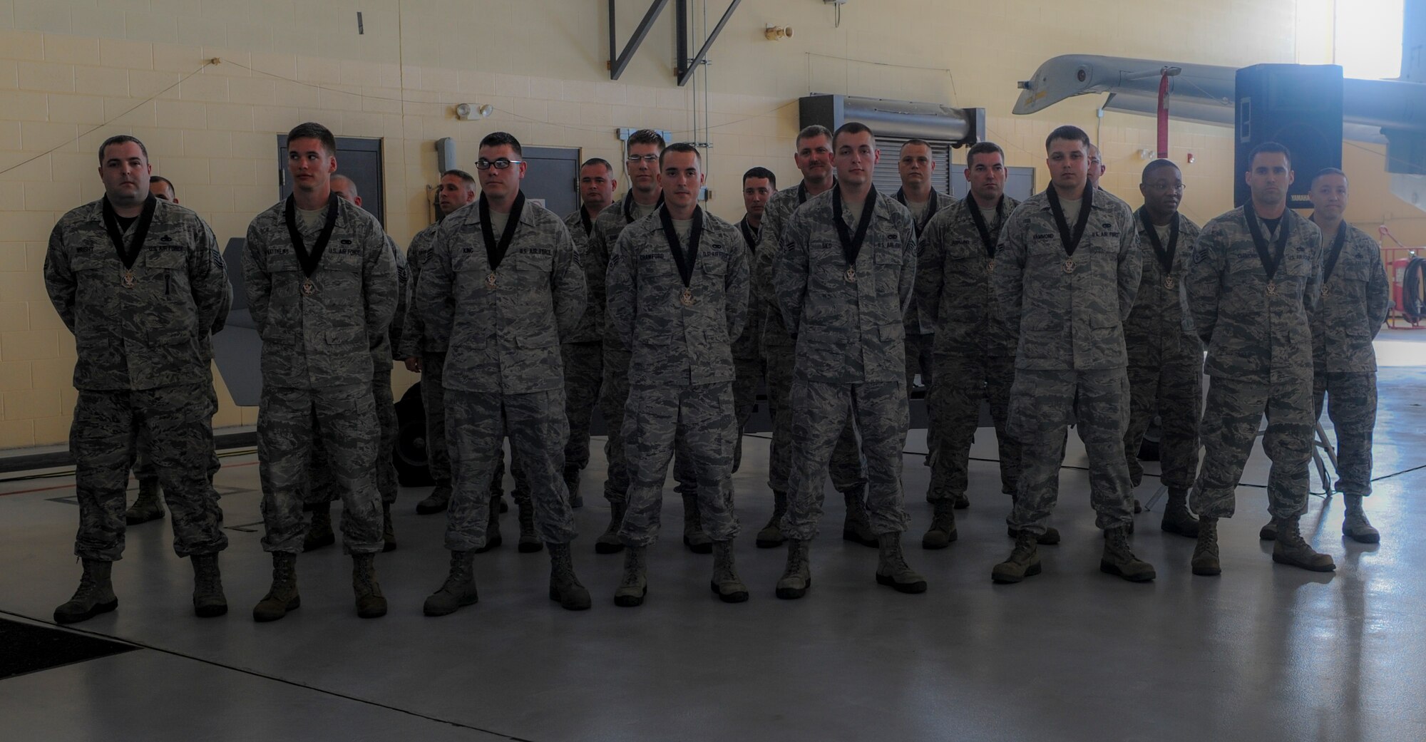 Nominees from the 23d Maintenance Group stand after being awarded medallions during the Maintenance Professional of the Year banquet at Moody Air Force Base, Ga., April 25, 2014. The medallions symbolized nomination for an award which was presented at the end of the night. (U.S. Air Force photo by Airman 1st Class Alexis Millican/Released)