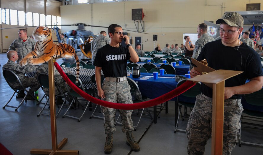 Airmen from the 23d Maintenance Group check names for exclusive entrance into the ‘VIP’ section of seats at Moody Air Force Base, Ga., April 25, 2014. The section was reserved for the 23d Aircraft Maintenance Squadron during the 2014 Maintenance Professional of the Year banquet. (U.S. Air Force photo by Airman 1st Class Alexis Millican/Released)