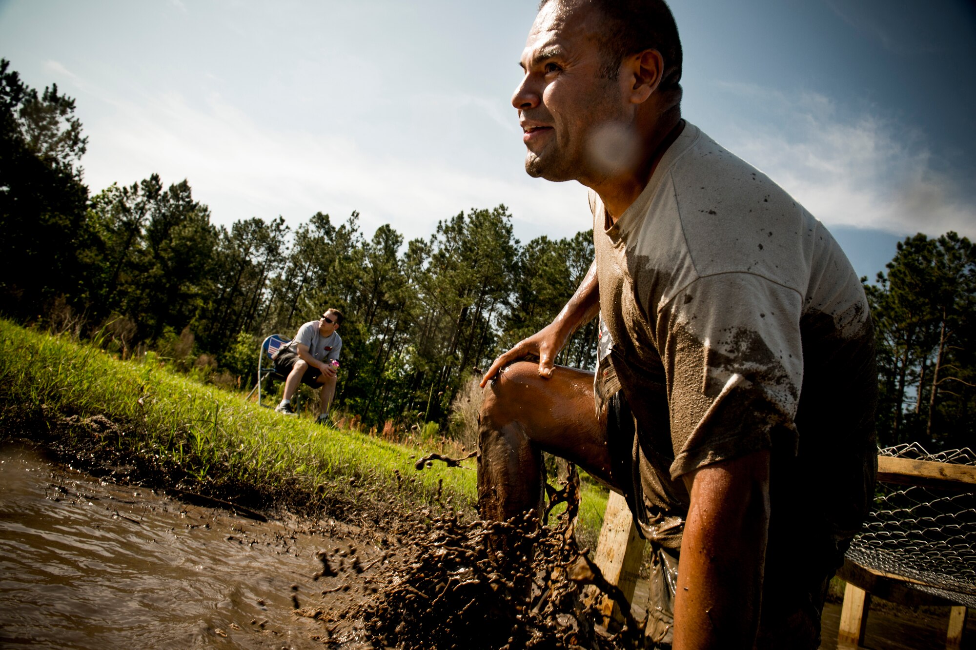 U.S. Air Force Chief Master Sgt. Manuel Camacho, 23d Security Forces Squadron, makes his way through an obstacle during the Moody Mudder run April 26, 2014, in Ray City, Ga. The event took place at Possum Creek All-Terrain Vehicle Park and featured two courses—a 5k course designed for teenagers and adults and a 2K course tailored for children. (U.S. Air Force photo by Staff Sgt. Jamal D. Sutter/Released)  