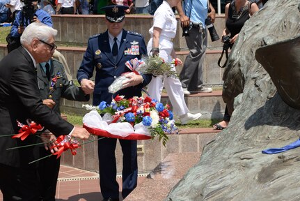 Air Force Gen. Robin Rand, Air Education Training and Command commander, participates in laying a floral tribute at the Monument for the Battle of Hill 881 South (with James Fenimore, Alamo Chapter 366 Vietnam Veterans of America commissioner, and Jack Hebdon, Fiesta San Antonio Commission president) during the Fiesta 2014 All Veterans Memorial Service Floral Tribute Procession in Veterans Square, San Antonio. Since 1891, Fiesta events observe the heroes of the Alamo and the Battle of San Jacinto. The Chapter 366 Vietnam Veterans’ memorial service honors U.S. military members, past and present, for their dedicated service. All who participated in the floral tribute procession had an opportunity to donate a floral offering during the ceremony. (U.S. Air Force photo by Johnny Saldivar)