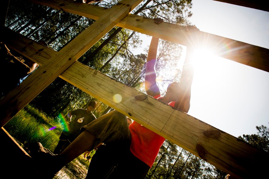Kenya Yarbrough begins to climb a wooden platform during the Moody Mudder run April, 26, 2014, in Ray City, Ga. The course also featured obstacles such as a log crawl, monkey bars and a fire pit. (U.S. Air Force photo by Staff Sgt. Jamal D. Sutter/Released) 
