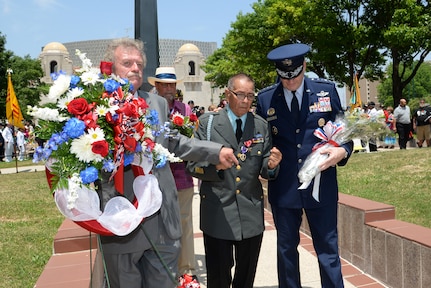 Air Force Gen. Robin Rand, Air Education Training and Command commander, participates in laying a floral tribute at the Monument for the Battle of Hill 881 South (with James Fenimore, Alamo Chapter 366 Vietnam Veterans of America commissioner, and Jack Hebdon, Fiesta San Antonio Commission president) during the Fiesta 2014 All Veterans Memorial Service Floral Tribute Procession in Veterans Square, San Antonio. Since 1891, Fiesta events observe the heroes of the Alamo and the Battle of San Jacinto. The Chapter 366 Vietnam Veterans’ memorial service honors U.S. military members, past and present, for their dedicated service. All who participated in the floral tribute procession had an opportunity to donate a floral offering during the ceremony. (U.S. Air Force photo by Johnny Saldivar)