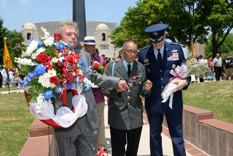 Air Force Gen. Robin Rand, Air Education Training and Command commander, participates in laying a floral tribute at the Monument for the Battle of Hill 881 South (with James Fenimore, Alamo Chapter 366 Vietnam Veterans of America commissioner, and Jack Hebdon, Fiesta San Antonio Commission president) during the Fiesta 2014 All Veterans Memorial Service Floral Tribute Procession in Veterans Square, San Antonio. Since 1891, Fiesta events observe the heroes of the Alamo and the Battle of San Jacinto. The Chapter 366 Vietnam Veterans’ memorial service honors U.S. military members, past and present, for their dedicated service. All who participated in the floral tribute procession had an opportunity to donate a floral offering during the ceremony. (U.S. Air Force photo by Johnny Saldivar)