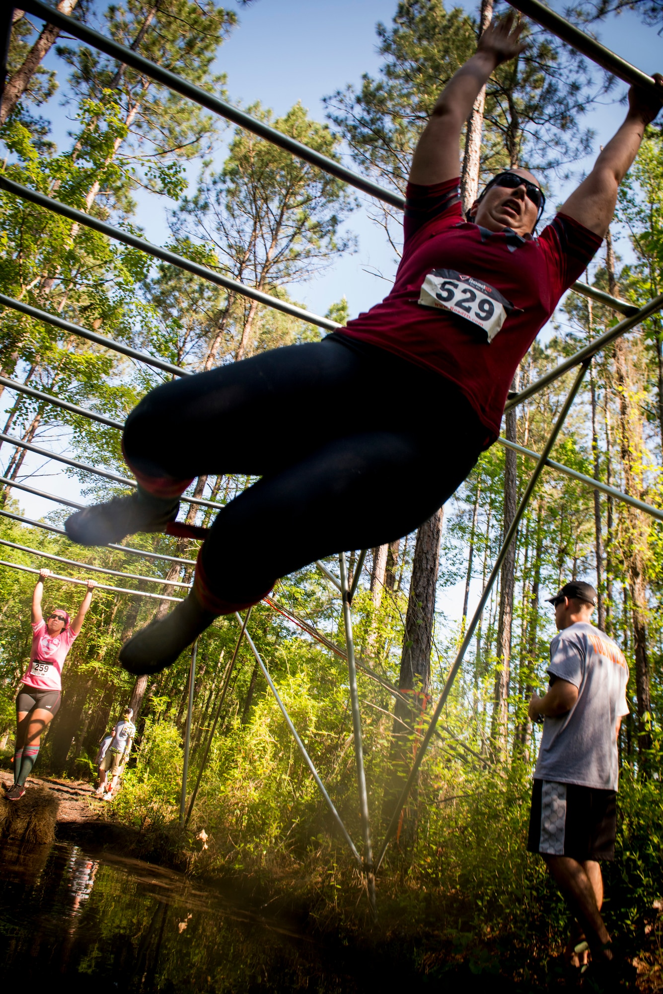 A Moody Mudder participant completes a monkey bars obstacle April, 26, 2014, in Ray City, Ga. More than 500 Airmen and members of the community took part in the event which was in its inaugural year. (U.S. Air Force photo by Staff Sgt. Jamal D. Sutter/Released) 