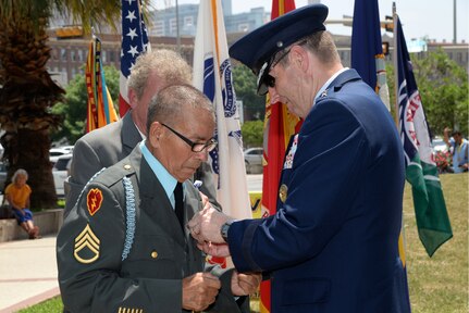 Air Force Gen. Robin Rand, Air Education Training and Command commander, and U.S. Congressman Lloyd Doggett, honor Vietnam Veteran Condalario Trevino as he receives a Purple Heart and a Bronze Star with Valor April 27 in Veterans Square during San Antonio’s 2014 Fiesta. Since 1891, Fiesta events have honored the heroes of the Alamo and the Battle of San Jacinto. The Alamo Chapter 366 Vietnam Veterans of America’s annual memorial in Veterans Square honors all U.S. military members for their service and sacrifice in protecting American’s freedom. (U.S. Air Force photo by Johnny Saldivar)