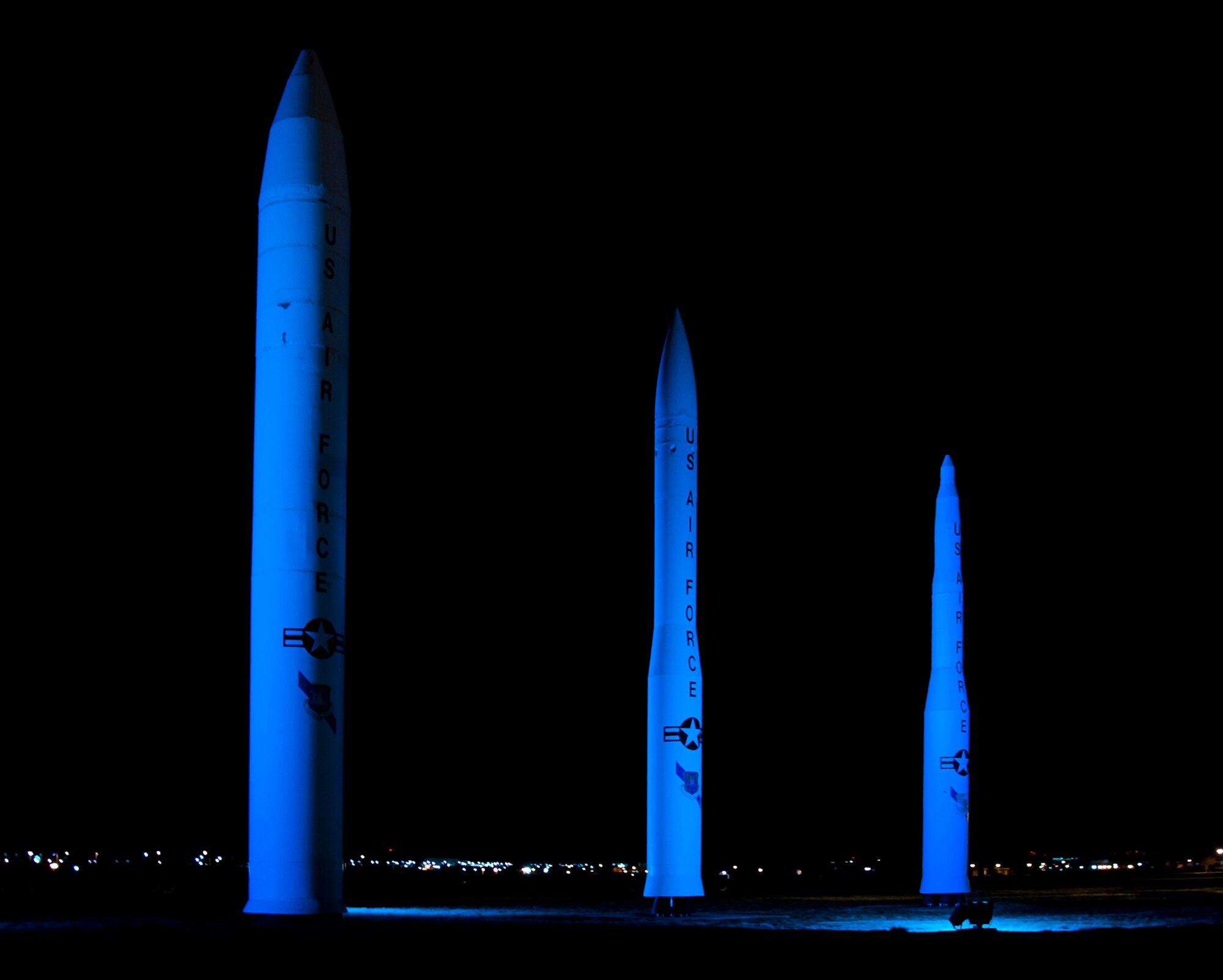 140425-F-CQ929-014 The F.E. Warren Air Force Base, Wyo., front gate missiles glow teal for the month of April in support of sexual assault awareness month. The base held a number of activities to help raise awareness for on base Airmen, and the teal missiles helped bring awareness to those driving by the base at night. (U.S. Air Force photo by Airman Malcolm Mayfield)