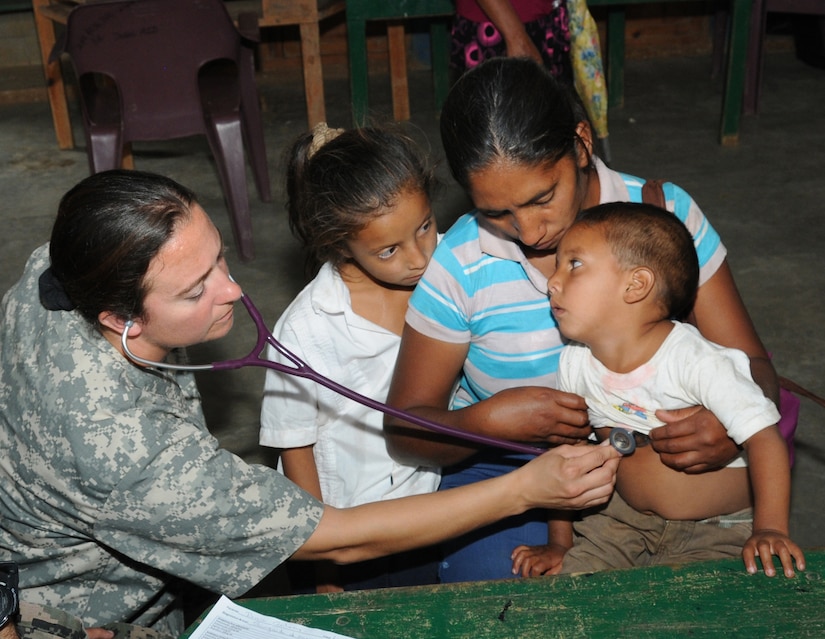 U. S. Army Capt. Emily Hollis listens to a Honduran child's heart while examining him during a Medical Readiness Training Exercise in El Naranjo, a remote village in the La Paz region of Honduras, April 24-25.  The Medical Element, with support from JTF-Bravo Joint Security Forces, partnered with the Honduran Ministry of Health, the Honduran National Police, and the Honduran military to provide medical care to nearly 1,000 people over a two day period.  The teams worked together to provide preventive medicine to their patients which included classes on hygiene, hand washing, preventive dental care, and nutrition.  They also provided immunizations to infants, dental care, well women screenings, wellness checkups, medications, and minor medical procedures.  (Photo by U. S. Air National Guard Capt. Steven Stubbs)