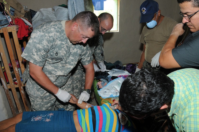 U. S. Army Sgt. 1st Class Noah Cunningham observes a Honduran patient after U. S Army Sgt. Kevin Bargery administered an intravenous drip during a Medical Readiness Training Exercise in El Naranjo, a remote village in the La Paz region of Honduras, April 24-25.  The Medical Element, with support from JTF-Bravo Joint Security Forces, partnered with the Honduran Ministry of Health, the Honduran National Police, and the Honduran military to provide medical care to nearly 1,000 people over the two day period.  The teams worked together to provide preventive medicine to their patients which included classes on hygiene, hand washing, preventive dental care, and nutrition.  They also provided immunizations to infants, dental care, well women screenings, wellness checkups, medications, and minor medical procedures.  (Photo by U. S. Air National Guard Capt. Steven Stubbs)