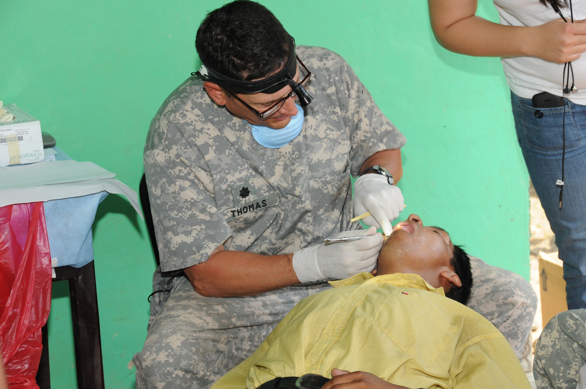 U. S. Army dentist Lt. Col. Mauri Thomas performs a dental examination during a Medical Readiness Training Exercise in El Naranjo, a remote village in the La Paz region of Honduras, April 24-25.  The Medical Element, with support from JTF-Bravo Joint Security Forces, partnered with the Honduran Ministry of Health, the Honduran National Police, and the Honduran military to provide medical care to nearly 1,000 people over a two day period.  The teams worked together to provide preventive medicine to their patients which included classes on hygiene, hand washing, preventive dental care, and nutrition.  They also provided immunizations to infants, dental care, well women screenings, wellness checkups, medications, and minor medical procedures.  (Photo by U. S. Air National Guard Capt. Steven Stubbs)