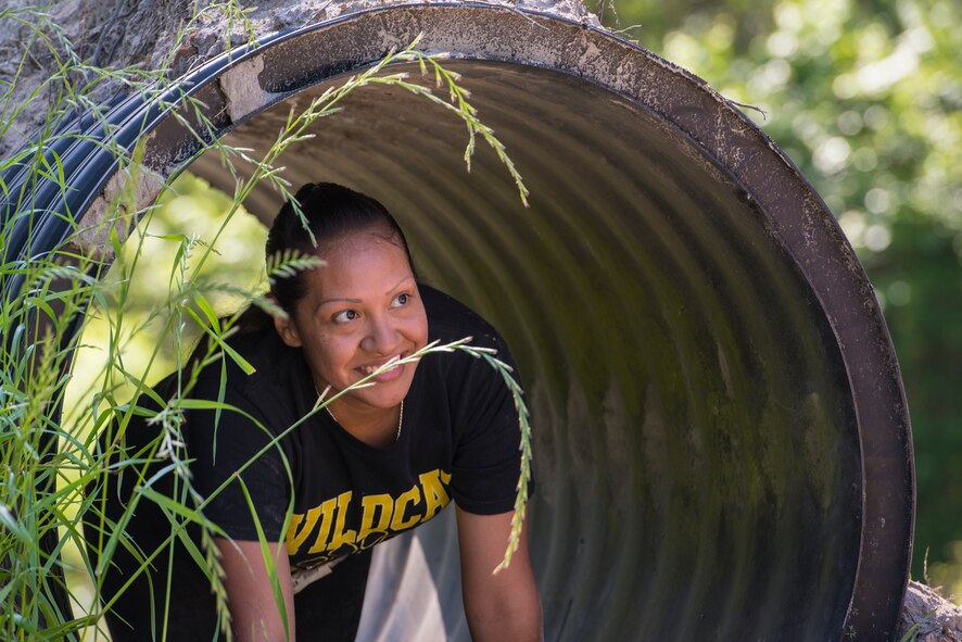A runner peaks out the end of a short tunnel obstacle during a mud-run in Ray City, Ga., April 26, 2014. The inaugural Moody Mudder 5k had more than 500 participants comprised of Moody Airmen and their families as well as members of the local community. Throughout the 3.12 miles, runners had to overcome obstacles such as barbed wire, monkey bars, low crawls, balance beams and climbing walls. (U.S. Air Force photo by Airman 1st Class Ryan Callaghan/Released)