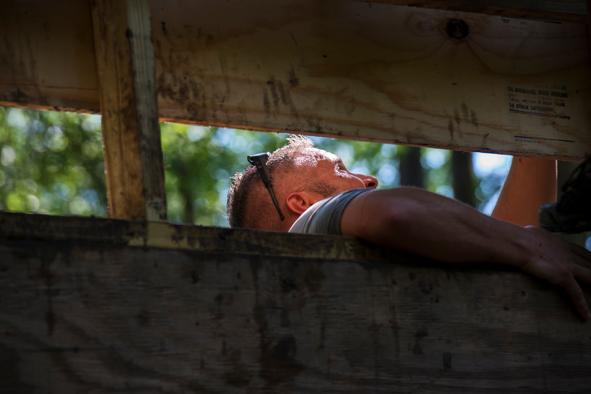 A runner helps a fellow participant get to the top of a climbing wall during a mud-run in Ray City, Ga., April 26, 2014. The inaugural Moody Mudder 5k had more than 500 participants comprised of Moody Airmen and their families as well as members of the local community. Throughout the 3.12 miles, runners had to overcome obstacles such as barbed wire, monkey bars, low crawls, balance beams and climbing walls. (U.S. Air Force photo by Airman 1st Class Ryan Callaghan/Released)