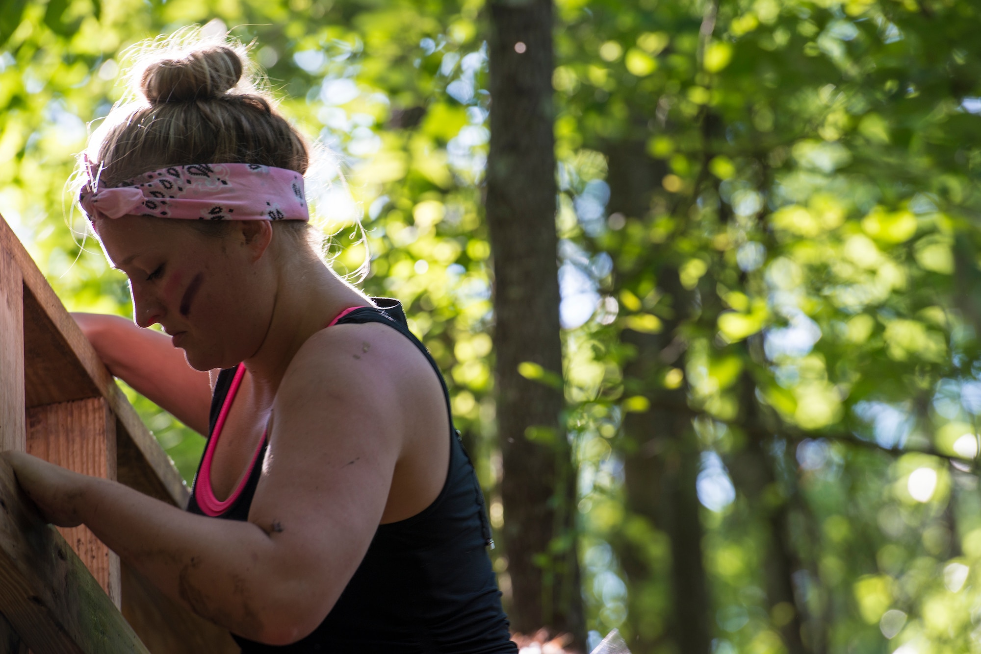 A runner lowers herself off the top of a climbing wall during a mud-run in Ray City, Ga., April 26, 2014. The inaugural Moody Mudder 5k had more than 500 participants comprised of Moody Airmen and their families as well as members of the local community. Throughout the 3.12 miles, runners had to overcome obstacles such as barbed wire, monkey bars, low crawls, balance beams and climbing walls. (U.S. Air Force photo by Airman 1st Class Ryan Callaghan/Released)