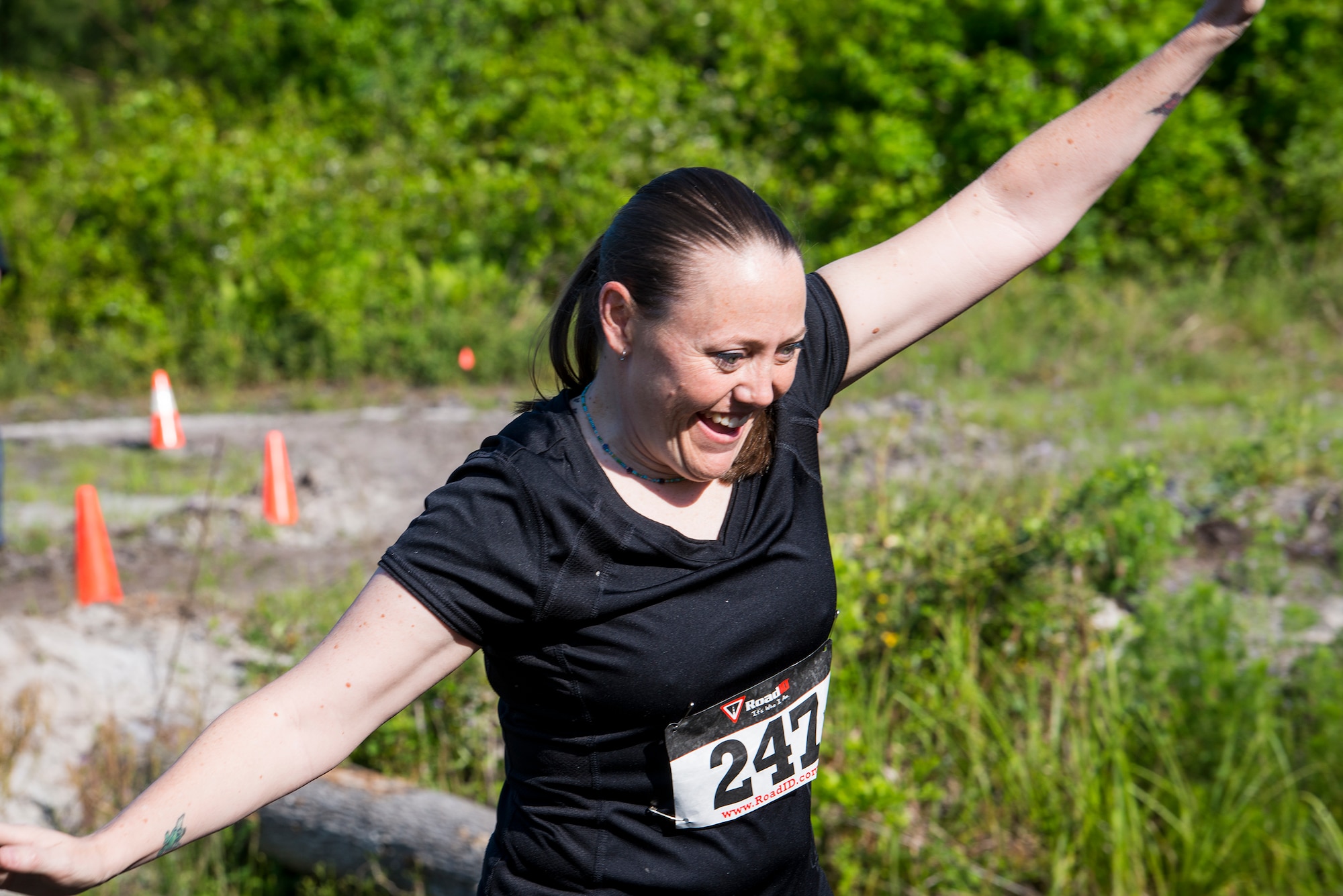 U.S. Air Force Tech. Sgt. Sasha Barker, 347th Operations Support Squadron independent duty medical technician, maintains her balance across a log balance beam obstacle during a mud-run in Ray City, Ga., April 26, 2014. The inaugural Moody Mudder 5k had more than 500 participants comprised of Moody Airmen and their families as well as members of the local community. Throughout the 3.12 miles, runners had to overcome obstacles such as barbed wire, monkey bars, low crawls, balance beams and climbing walls. (U.S. Air Force photo by Airman 1st Class Ryan Callaghan/Released)