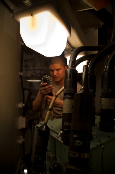 Airman 1st Class Salvador Gomez, 91st Missile Maintenance Squadron electro-mechanical team maintenance technician, connects a cord to the distribution box during training at Minot Air Force Base, N.D., April 09, 2014. The 91st Maintenance Group is responsible for providing maintenance and logistics support for the wing's ICBM fleet. (U.S. Air Force photo/Senior Airman Brittany Y. Auld)
