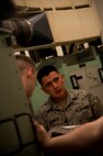 Senior Airman Mario Bennett, 91st Missile Maintenance Squadron electro-mechanical team maintenance technician, reads off instructions from a manual during training at Minot Air Force Base, N.D., April 09, 2014. The 91st Maintenance Group is the maintenance backbone of the 91st Missile Wing. The group was originally activated as the 91st Maintenance and Supply Group on November 10, 1948. Today, the group is responsible for providing maintenance and logistics support for the wing's ICBM fleet.  (U.S. Air Force photo/Senior Airman Brittany Y. Auld)