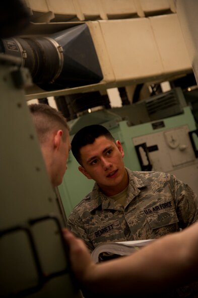 Senior Airman Mario Bennett, 91st Missile Maintenance Squadron electro-mechanical team maintenance technician, reads off instructions from a manual during training at Minot Air Force Base, N.D., April 09, 2014. The 91st Maintenance Group is the maintenance backbone of the 91st Missile Wing. The group was originally activated as the 91st Maintenance and Supply Group on November 10, 1948. Today, the group is responsible for providing maintenance and logistics support for the wing's ICBM fleet.  (U.S. Air Force photo/Senior Airman Brittany Y. Auld)
