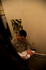 Senior Airman Mario Bennett, 91st Missile Maintenance Squadron electro-mechanical team maintenance technician, reads off instructions from a manual during training at Minot Air Force Base, N.D., April 09, 2014. The 91st Maintenance Group is the maintenance backbone of the 91st Missile Wing. The group was originally activated as the 91st Maintenance and Supply Group on November 10, 1948. Today, the group is responsible for providing maintenance and logistics support for the wing's ICBM fleet.  (U.S. Air Force photo/Senior Airman Brittany Y. Auld)