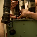 Electro-mechanical team maintenance technicians from the 91st Missile Maintenance Squadron connect a cord to the distribution box during training at Minot Air Force Base, N.D., April 09, 2014. The 91st Maintenance Group is responsible for providing maintenance and logistics support for the wing's ICBM fleet. (U.S. Air Force photo/Senior Airman Brittany Y. Auld)