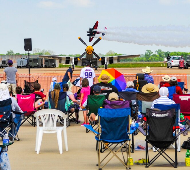 Spectators watch the Twin Beech 18, piloted by Matt Younkin, perform an aerobatic maneuver at the Defenders of Liberty Air Show on Barksdale Air Force Base, La., April 26, 2014. The Twin Beech 18, built in 1943, was originally purchased by the Army Air Corps and has a top speed of 250 miles per hour.(U.S. Air Force photo/Airman 1st Class Benjamin Raughton)