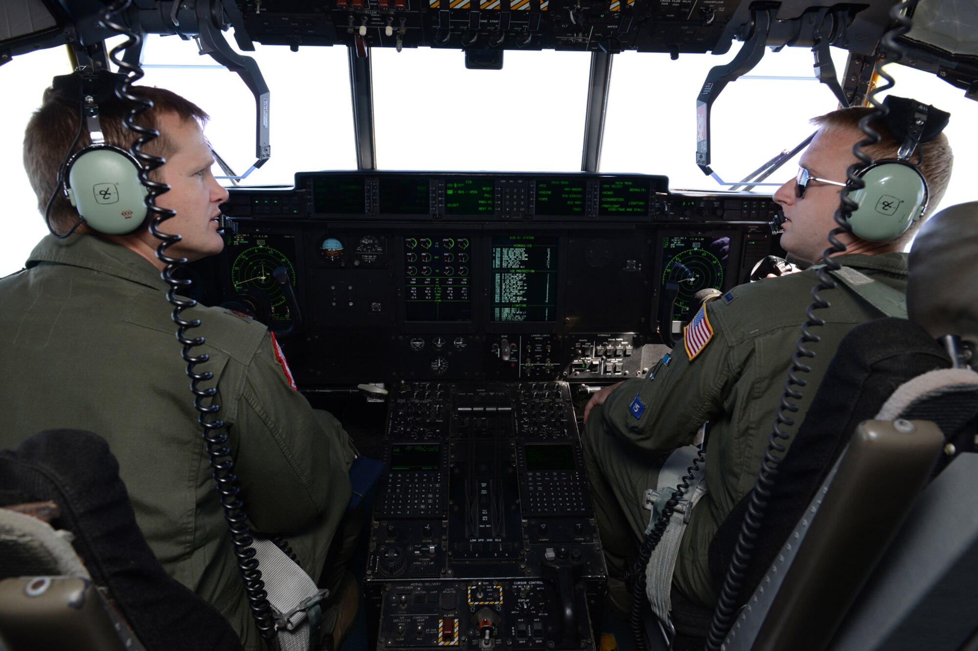 Maj. Dominic Barberi, 403rd Operations Group pilot (left) and 1st Lt. Chase Allen, 53rd Weather Reconnaissance Squadron pilot, discuss in-flight training scenarios to be performed for aeromedical evacuation students and instructors during a training flight out of Pope Field, N.C., April 26. Aircrew members from the 53rd WRS “Hurricane Hunters," Keesler Air Force Base, Miss., participated in an aeromedical evacuation training exercise April 26-27 at Pope Field designed to teach students how to handle medical situations that might arise while transporting patients to their destination. (U.S. Air Force photo/Tech. Sgt. Ryan Labadens)