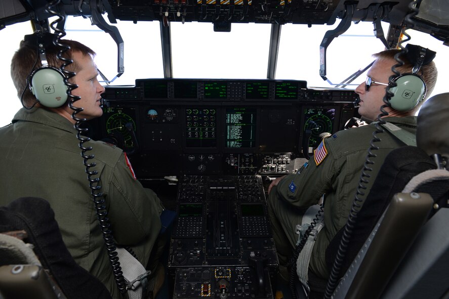 Maj. Dominic Barberi, 403rd Operations Group pilot (left) and 1st Lt. Chase Allen, 53rd Weather Reconnaissance Squadron pilot, discuss in-flight training scenarios to be performed for aeromedical evacuation students and instructors during a training flight out of Pope Field, N.C., April 26, 2014. Aircrew members from the 53rd WRS “Hurricane Hunters," Keesler Air Force Base, Miss., participated in an aeromedical evacuation training exercise April 26-27, 2014, at Pope Field designed to teach students how to handle medical situations that might arise while transporting patients to their destination. (U.S. Air Force photo/Tech. Sgt. Ryan Labadens) 

