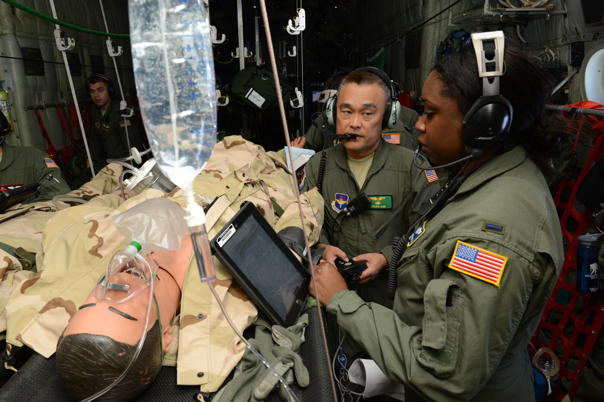 Lt. Col. Johan Ahn, a flight surgeon with the 81st Aerospace Medicine Squadron, Keesler Air Force Base, Miss., and 1st Lt. Keisha Burrell, a flight nurse with the 439th Aeromedical Evacuation Squadron, Westover Air Reserve Base, Mass., assess a “patient” suffering from simulated seizures during an aeromedical evacuation class at Pope Field, N.C., April 26. Aircrew members from the 53rd Weather Reconnaissance Squadron, Keesler Air Force Base, Miss., participated in an aeromedical evacuation training exercise April 26-27 at Pope Field designed to teach students how to handle medical situations that might arise while transporting patients to their destination. (U.S. Air Force photo/Tech. Sgt. Ryan Labadens)