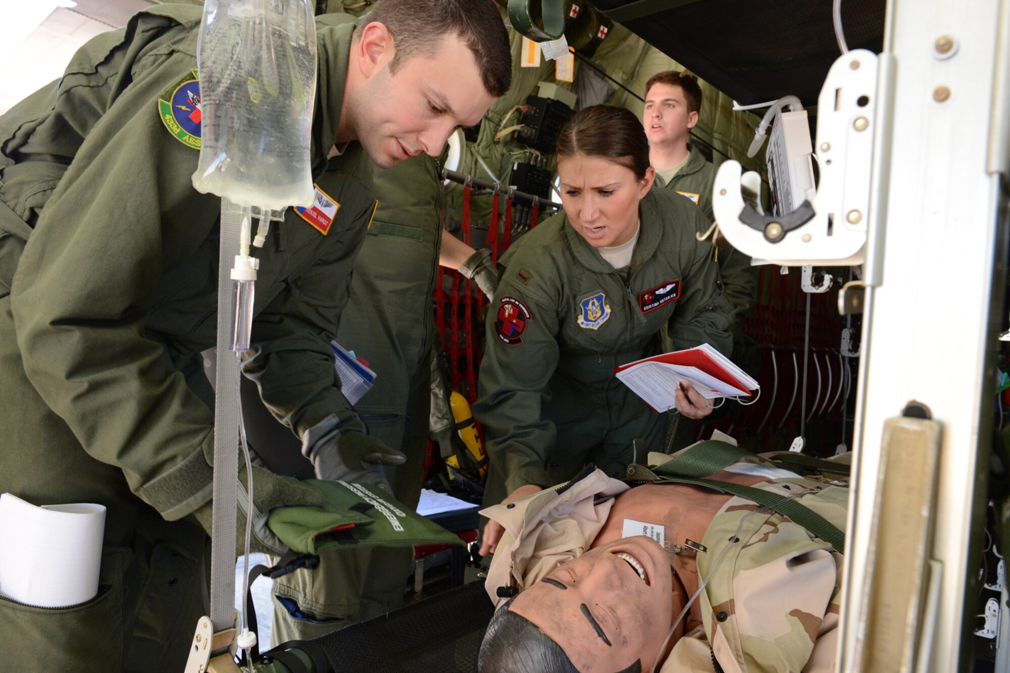 Second Lt. Ezekiel Varoz, a flight nurse with the 914th Aeromedical Evacutation Squadron, Niagara Falls Air Reserve Station, N.Y., and 2nd Lt. Kristina Krtanjek, a flight nurse with the 433rd Aeromedical Evacuation Squadron, Lackland Air Force Base, Texas, check to make sure a simulated patient is secured for takeoff on a 53rd Weather Reconnaissance Squadron WC-130J during an aeromedical evacuation class at Pope Field, N.C., April 26. Aircrew members from the 53rd Weather Reconnaissance Squadron, Keesler Air Force Base, Miss., participated in an aeromedical evacuation training exercise April 26-27 at Pope Field designed to teach students how to handle medical situations that might arise while transporting patients to their destination. (U.S. Air Force photo/Tech. Sgt. Ryan Labadens)