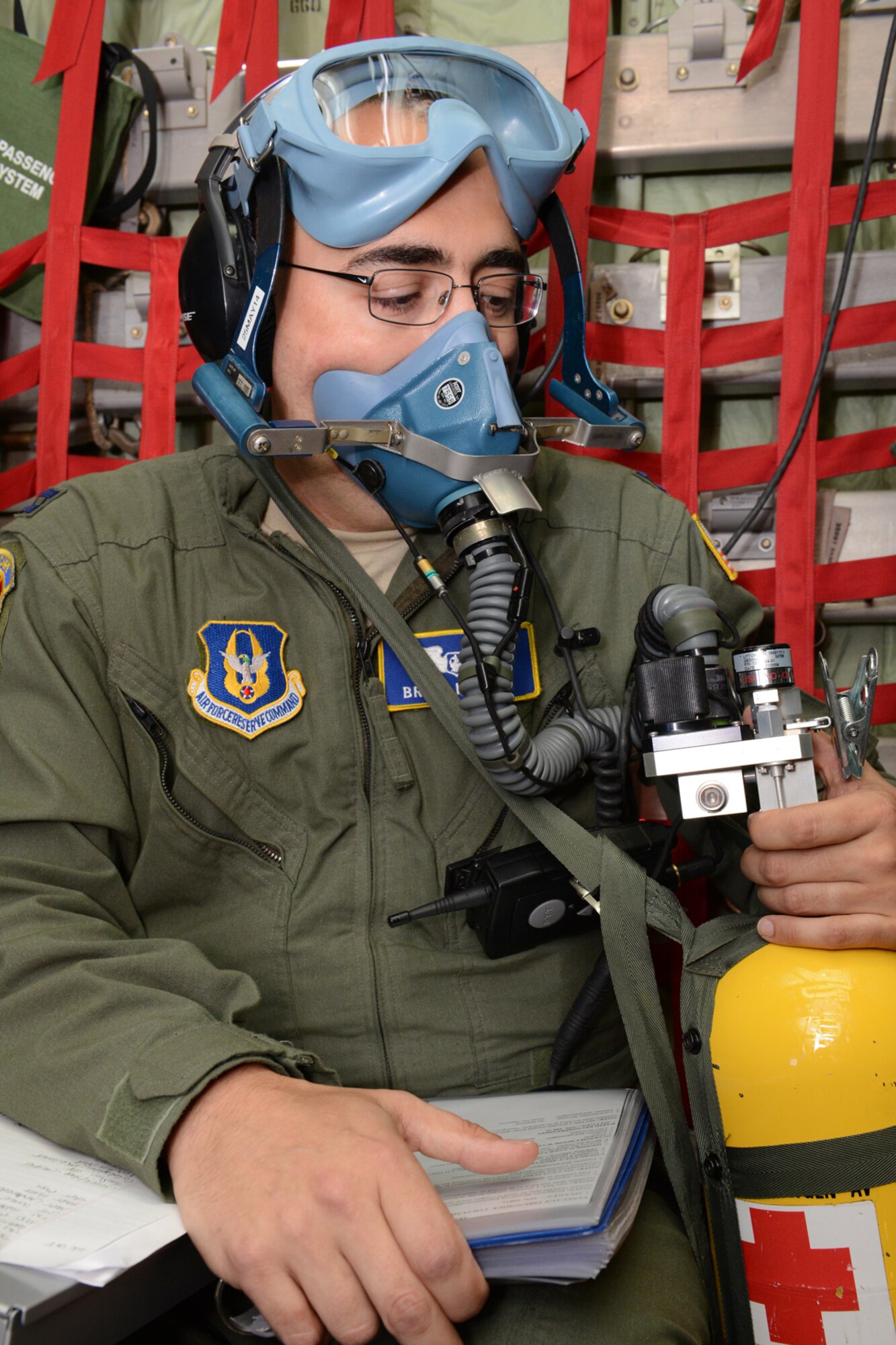Capt. Brian Martin, a 439th Aeromedical Evacuation Squadron flight nurse from Westover Air Reserve Base, Mass., dons a self-contained breathing apparatus for a simulated in-flight rapid decompression during an aeromedical evacuation class at Pope Field, N.C., April 26. Aircrew members from the 53rd Weather Reconnaissance Squadron, Keesler Air Force Base, Miss., flew in a WC-130J “Hurricane Hunter” aircraft from Keesler to participate in an aeromedical evacuation training exercise April 26-27 at Pope Field. The exercise was designed to teach students how to handle medical situations that might arise while transporting patients to their destination. (U.S. Air Force photo/Tech. Sgt. Ryan Labadens)