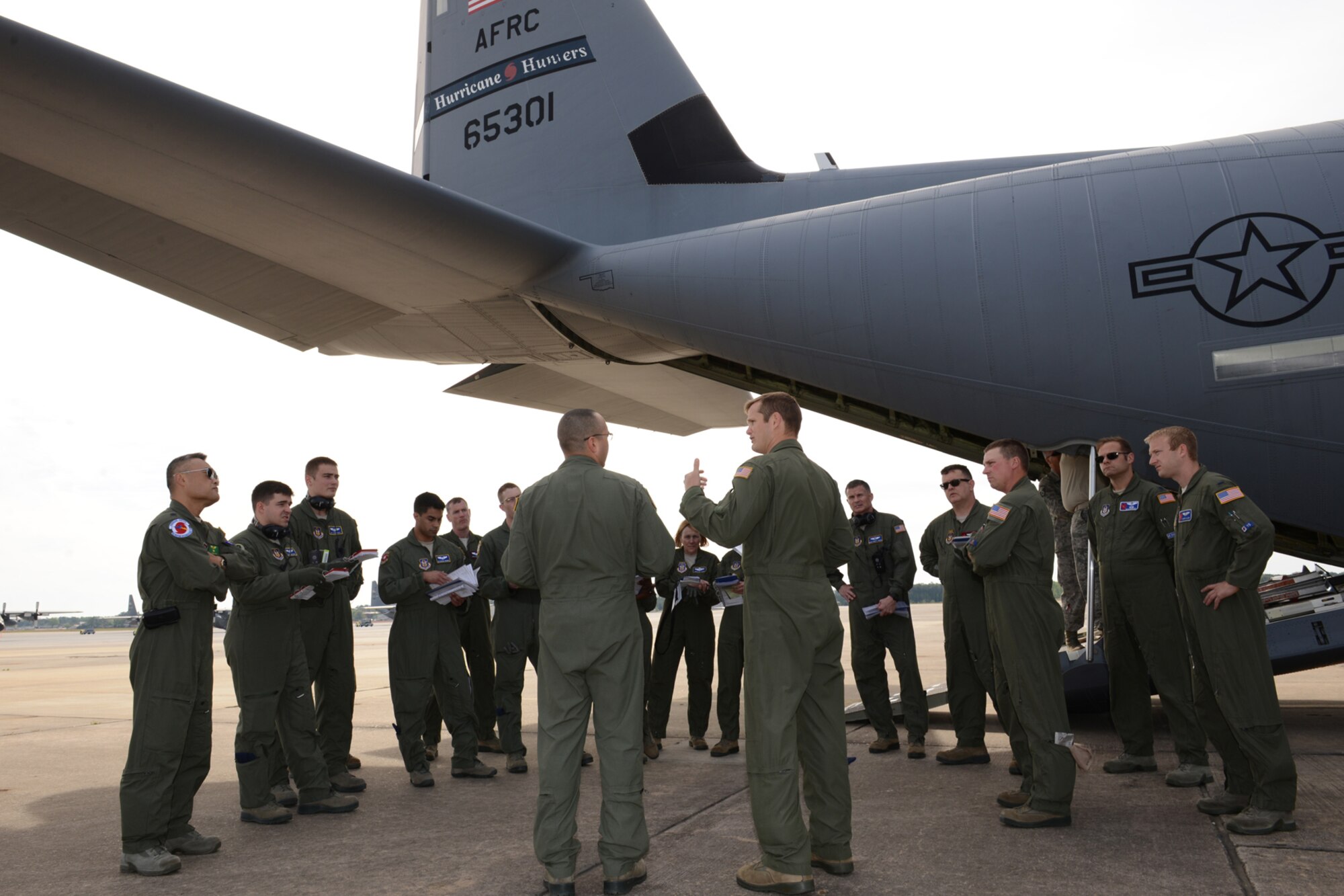 Maj. Dominic Barberi, 403rd Operations Group pilot (center right), gives a pre-flight safety briefing to students and instructors from an aeromedical evacuation class before boarding a WC-130J aircraft April 26 at Pope Field, N.C. Aircrew members from the 53rd Weather Reconnaissance Squadron, Keesler Air Force Base, Miss., participated in an aeromedical evacuation training exercise April 26-27 at Pope Field designed to teach students how to handle medical situations that might arise while transporting patients to their destination. (U.S. Air Force photo/Tech. Sgt. Ryan Labadens)