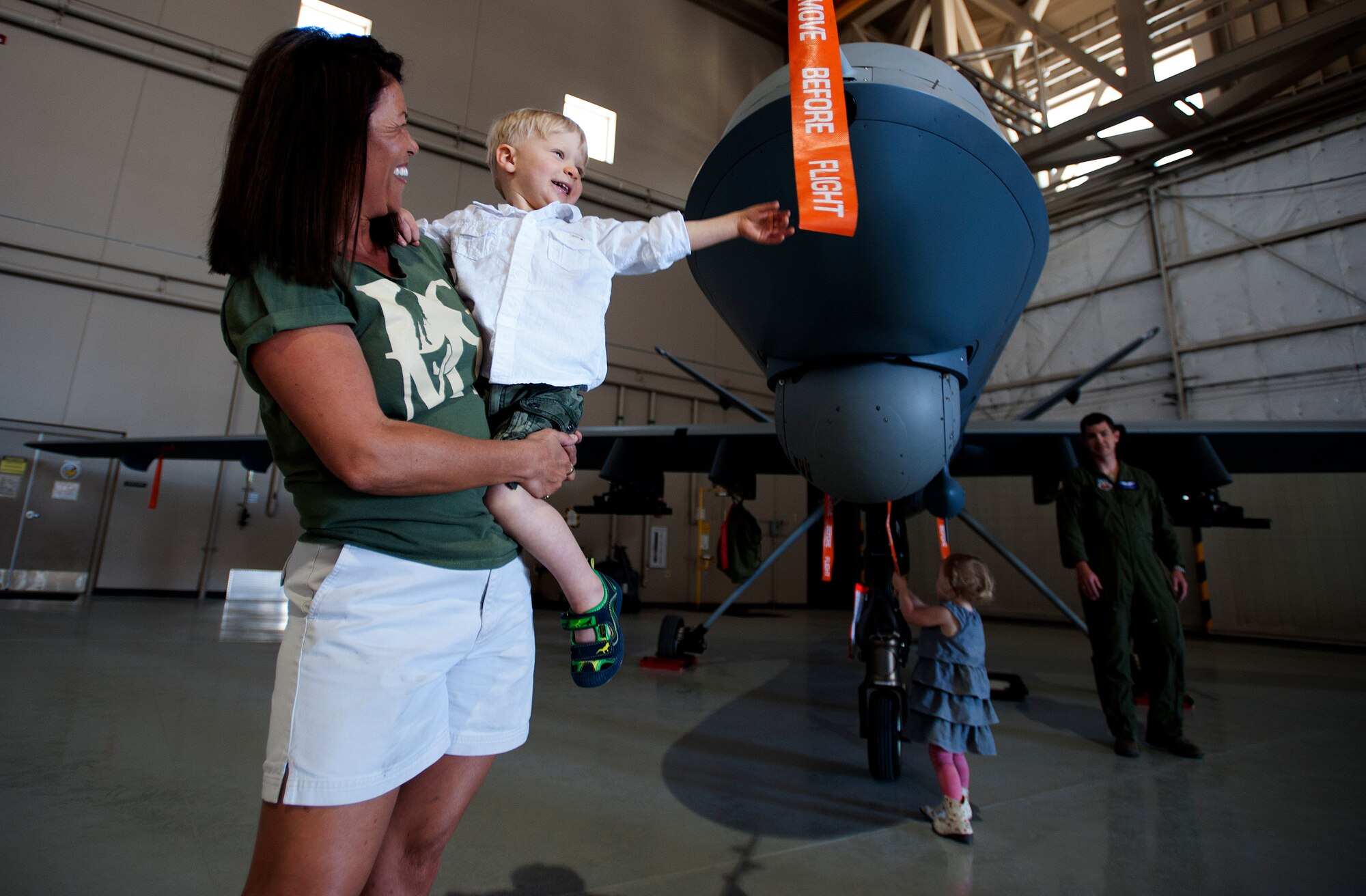 LJ Marchesse, two, touches an MQ-9 Reaper during the Take Our Daughters and Sons to Work Day hosted on Creech Air Force Base, Nev., April 24, 2014. During the day's events the Creech Airmen and Family Readiness Center provided a plethora of events including demonstrations from the local fire deparement, work center tours, and a professional magician and DJ.