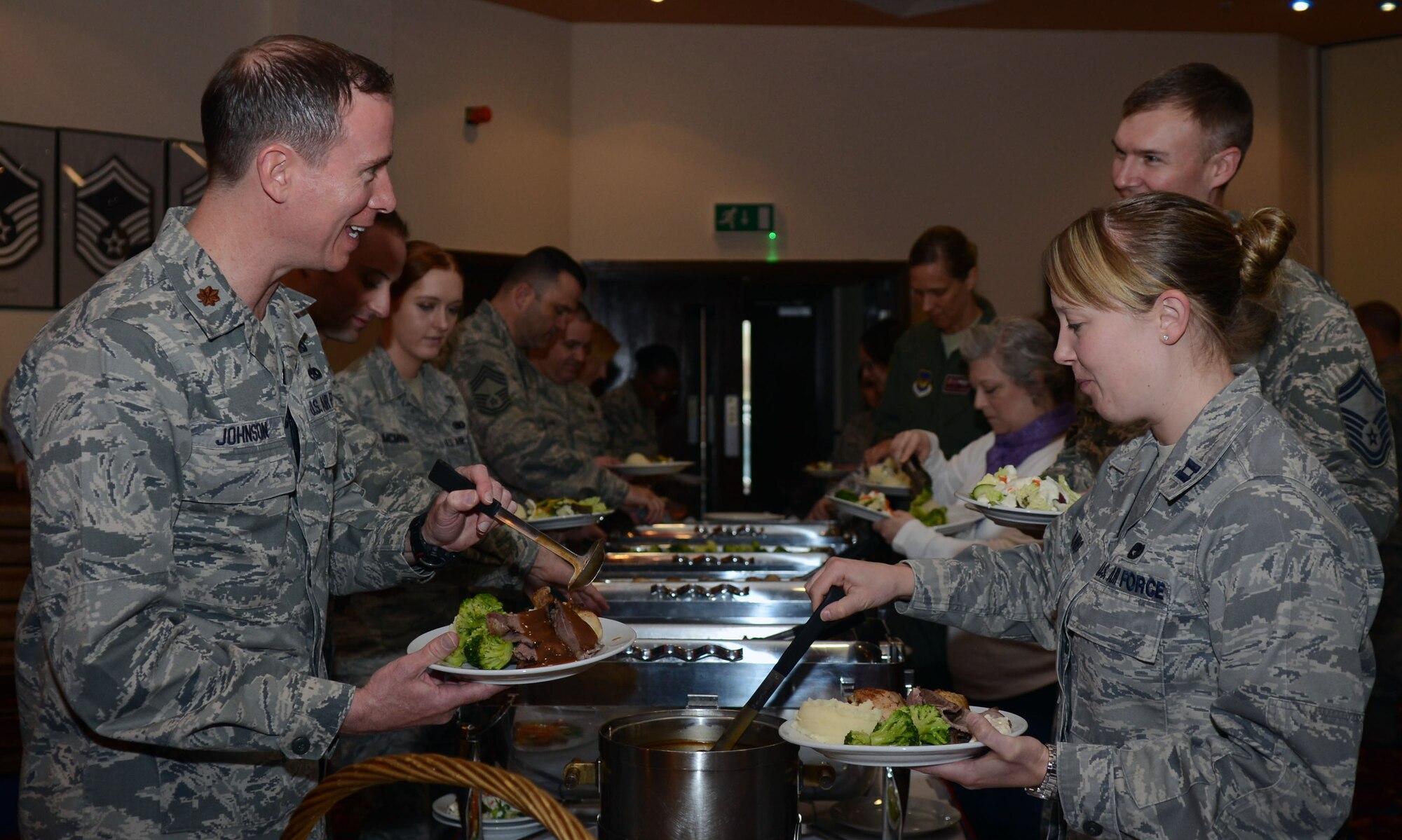Team Mildenhall members get food from a buffet April 28, 2014, during a Holocaust Remembrance Luncheon on RAF Mildenhall, England. Attendees were afforded the chance to hear first-hand stories of the holocaust from a former warrant officer in the Royal Electrical and Mechanical Engineers. (U.S. Air Force photo by Airman 1st Class Kyla Gifford/Released) 