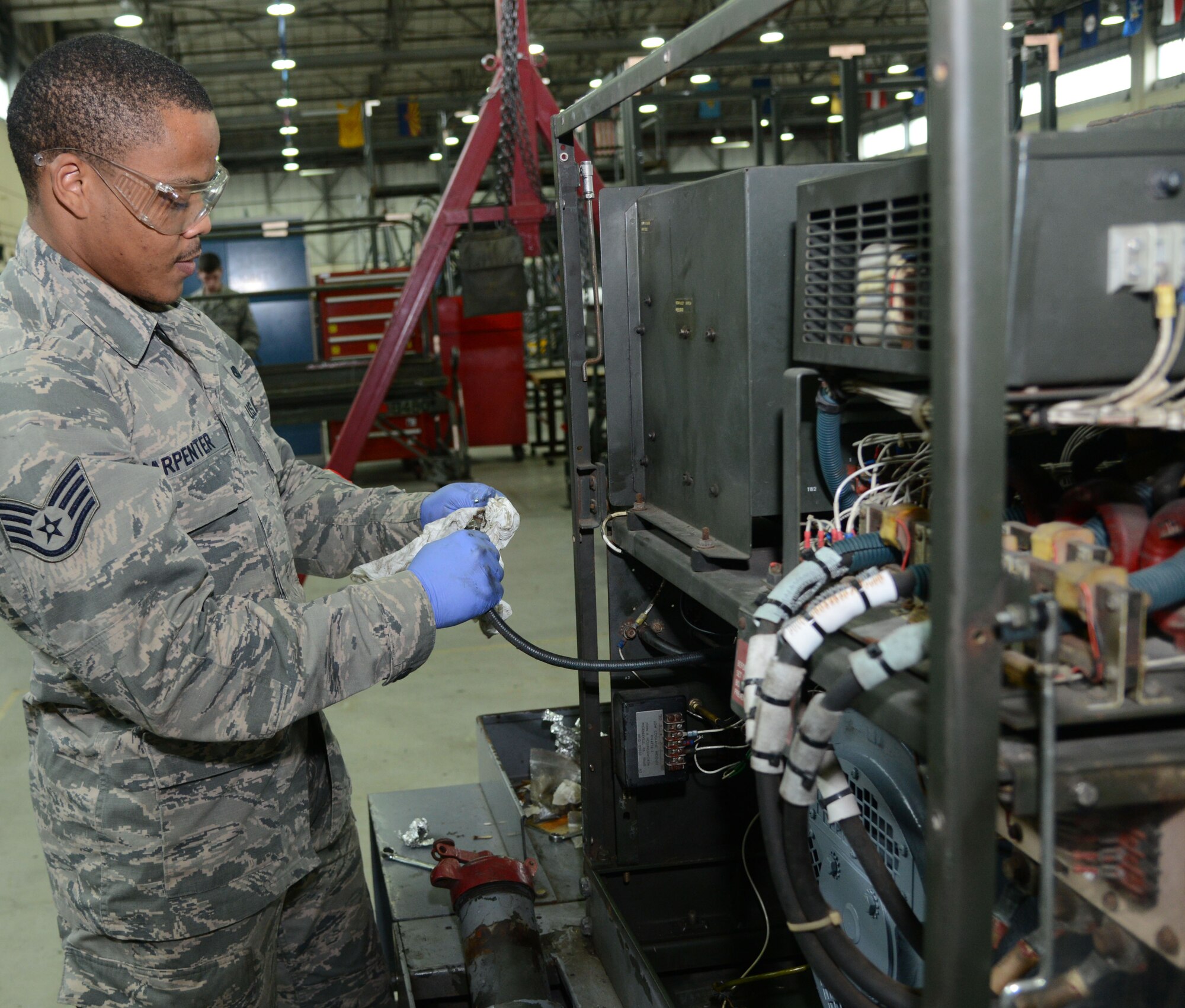 U.S. Air Force Staff Sgt. Corey Carpenter, 100th Maintenance Squadron Aerospace Ground Equipment journeyman, adjusts the wiring on an 86 Hobart generator April 23, 2014, on RAF Mildenhall, England. Generators provide power to an aircraft before engines start during pre-flight. (U.S. Air Force photo by Airman 1st Class Kelsey Waters/Released)