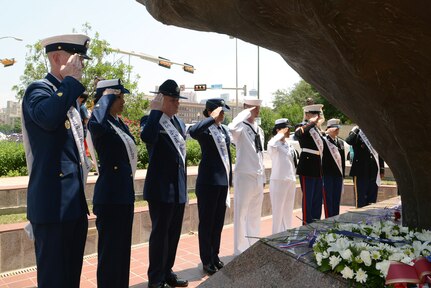 The Joint Base San Antonio Ambassadors salute April 27 during the Fiesta 2014 All Veterans Memorial Service in Veterans Square, San Antonio.  The Alamo Chapter 366 Vietnam Veterans of America program pays tribute to U.S. military members, past and present, for the dedication and sacrifices required of them in protecting American freedom. (U.S. Air Force photo by Johnny Saldivar)