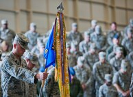 The 6th Special Operations Squadron first sergeant holds the guidon during the invocation at a change of command ceremony at Duke Field, Fla., April 25.  Lt. Col. Casey Ward took command of the squadron from Lt. Col. John Aalborg.  The 6th SOS is an active-duty combat aviation advisor squadron located at Duke Field Fla.  They work directly with the Reserve’s 5th Special Operations Squadron flying aviation foreign internal defense aircraft.  (U.S. Air Force photo/Tech. Sgt. Samuel King Jr.)