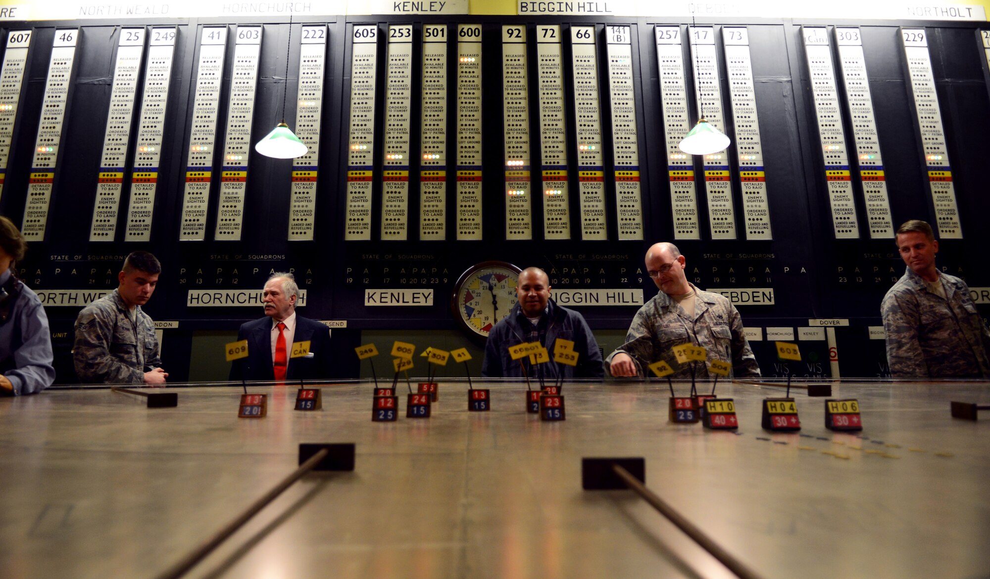 Team Mildenhall members examine a World War II era plotting table April 24, 2014, in the 11 Group bunker at RAF Uxbridge, England. The plotting table gave a visual representation of attacking and defending forces during an air battle. (U.S. Air Force photo by Airman 1st Class Dillon Johnston/Released)