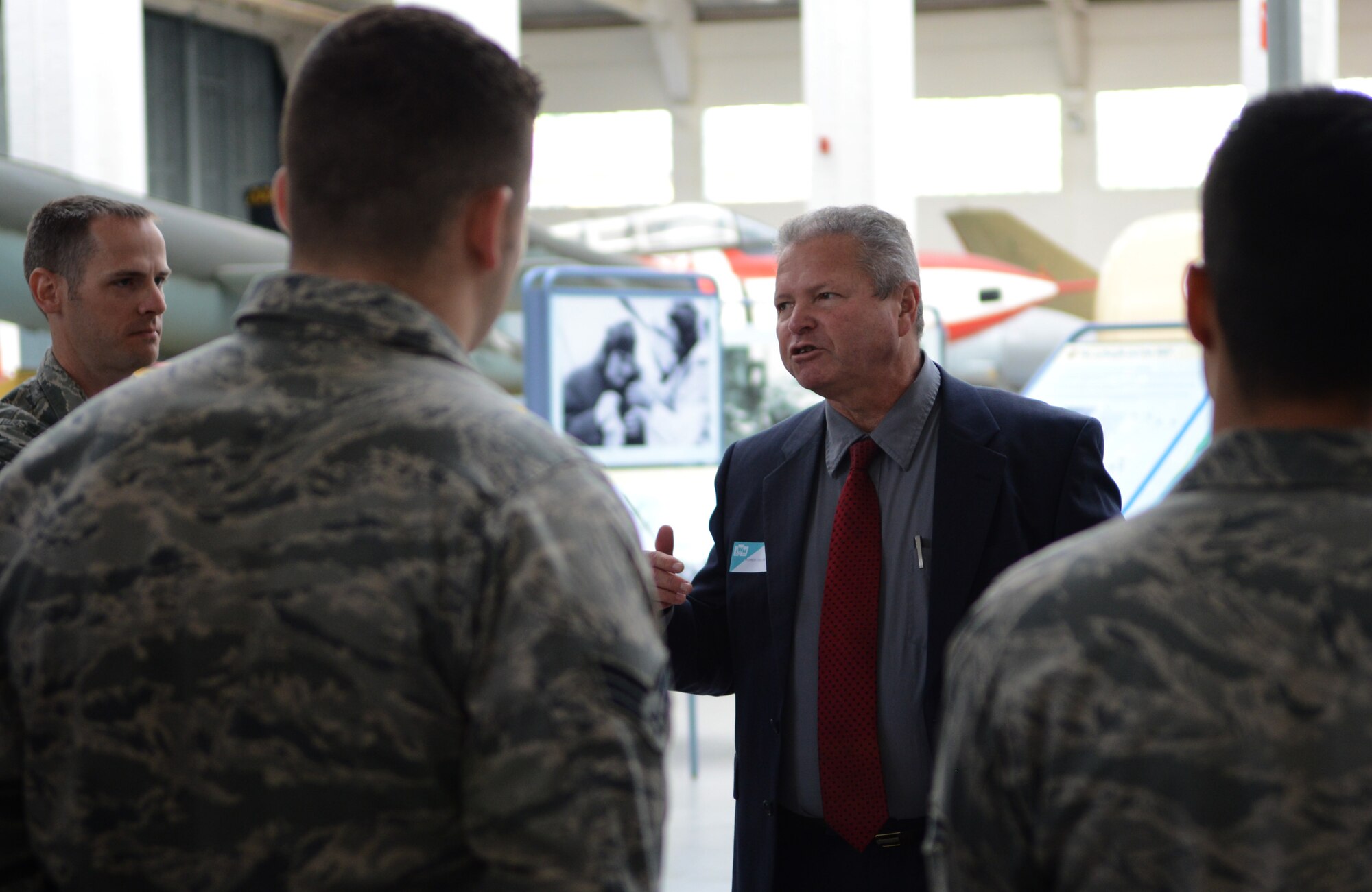 Mark Howell, center, 100th Air Refueling Wing historian from Odessa, Texas, speaks to Team Mildenhall members April 24, 2014, during a heritage visit to the Imperial War Museum Duxford, England. The museum was the first stop on a trip focused on the Battle of Britain, a decisive World War II air conflict between England and Germany in 1940. (U.S. Air Force photo by Airman 1st Class Dillon Johnston/Released) 
