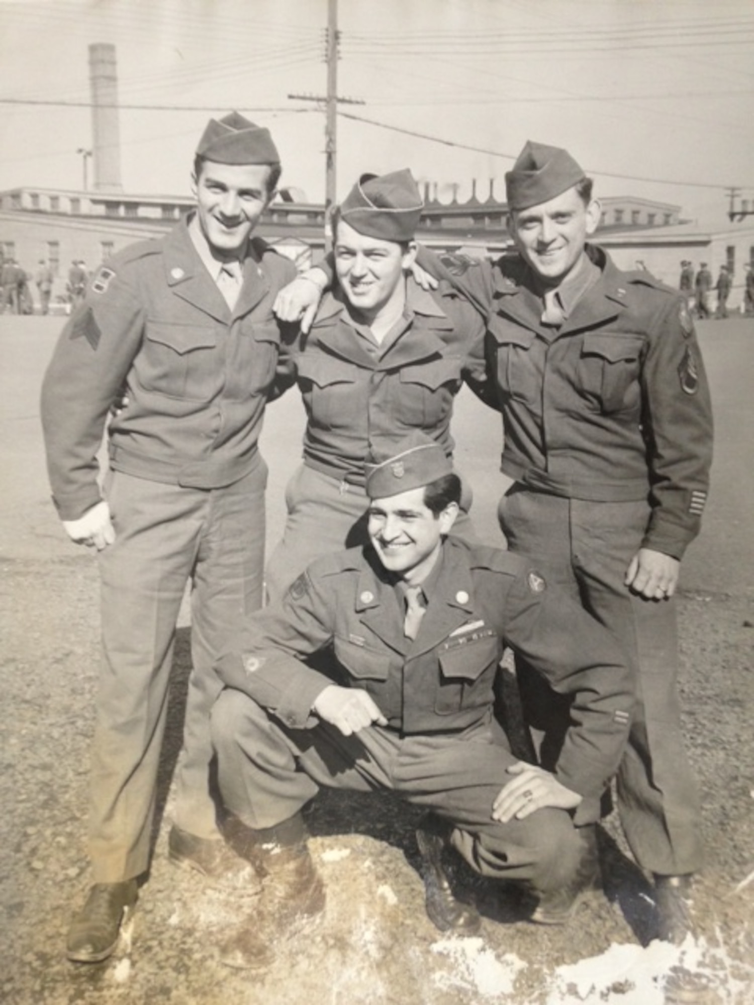 Sgt. Tom Boliaris, standing at left with unidentified fellow soldiers in 1946, served in the 371FG late in WWII, including when the group was based in Germany. (Courtesy Ms. Nancy Beaumier, daughter of 371FG veteran Cpl. Tom Boliaris)