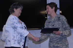 U.S. Army Capt. Christine Krueger, 128th Aviation Brigade, Advanced Individual Training D Company commander, receives the Yorktown Patriot Award from Linda Lee, co-chair of the Comte De Grasse Chapter of the National Society of the Daughters of the American Revolution, at Fort Eustis, Va., April 24. The Yorktown Patriot Award recognizes women in all branches of service who represent the values of “God, Country and Home.” (U.S. Air Force photo by 2nd Lt. Brooke Betit/Released)