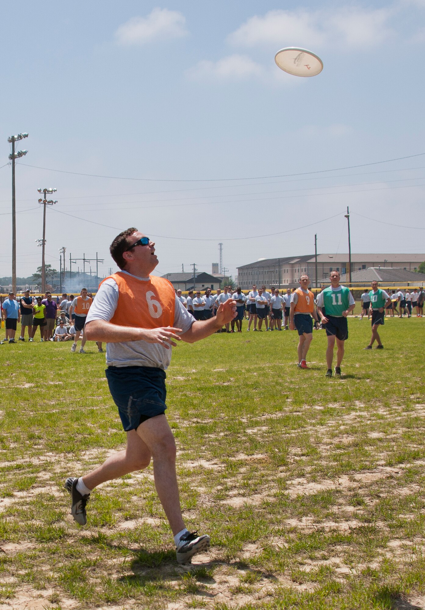 An Airman moves under a Frisbee to catch a pass at an ultimate Frisbee game during the 96th Test Wing’s Wingman Day event April 24 at Eglin Air Force Base, Fla.  The morning events were for unit training then everyone converged on Foster Stadium for food and field day activities.  The theme of this year’s event was “Everyone’s a Mentor.”  (U.S. Air Force photo/Samuel King Jr.)