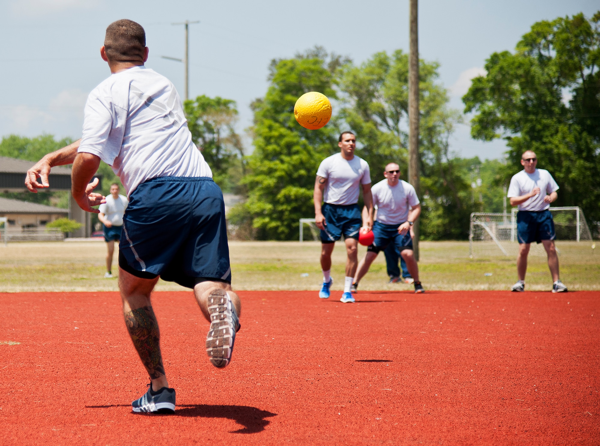 An Airman slings a dodge ball at an opponent during 96th Test Wing’s Wingman Day event April 24 at Eglin Air Force Base, Fla.  The morning events were for unit training then everyone converged on Foster Stadium for food and field day activities.  The theme of this year’s event was “Everyone’s a Mentor.”  (U.S. Air Force photo/Samuel King Jr.)