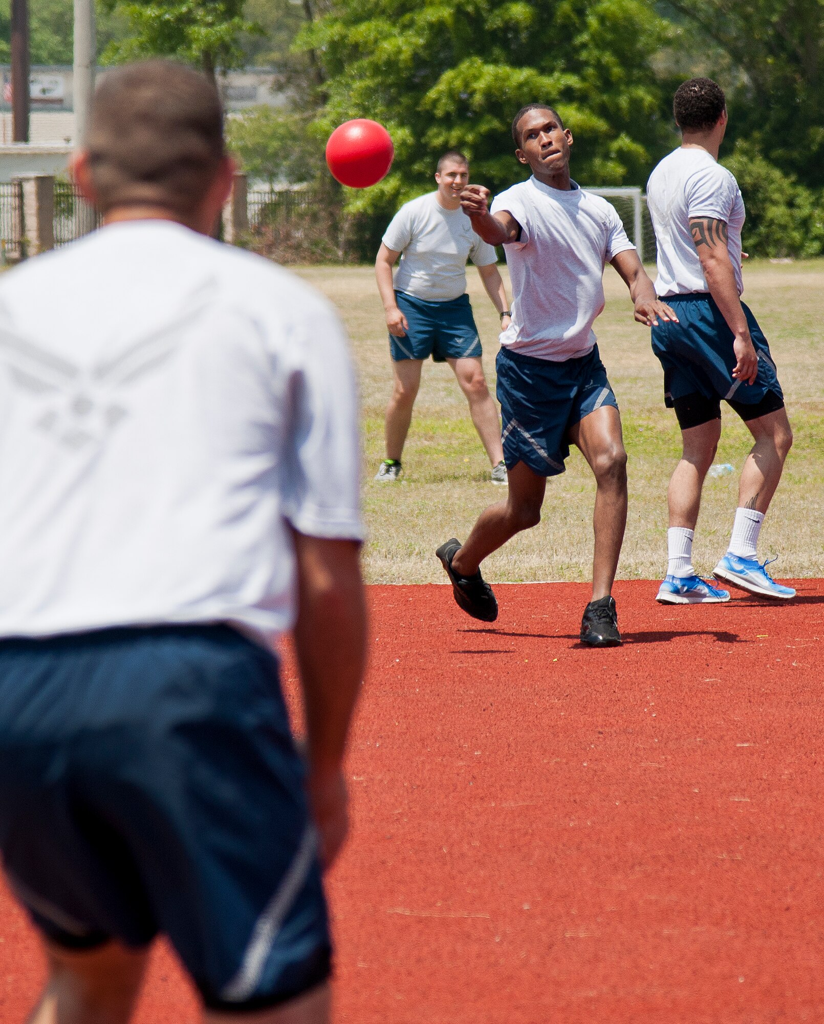 An Airman from the 96th Maintenance Group slings a dodge ball at an opponent during 96th Test Wing’s Wingman Day event April 24 at Eglin Air Force Base, Fla.  The morning events were for unit training then everyone converged on Foster Stadium for food and field day activities.  The theme of this year’s event was “Everyone’s a Mentor.”  (U.S. Air Force photo/Samuel King Jr.)